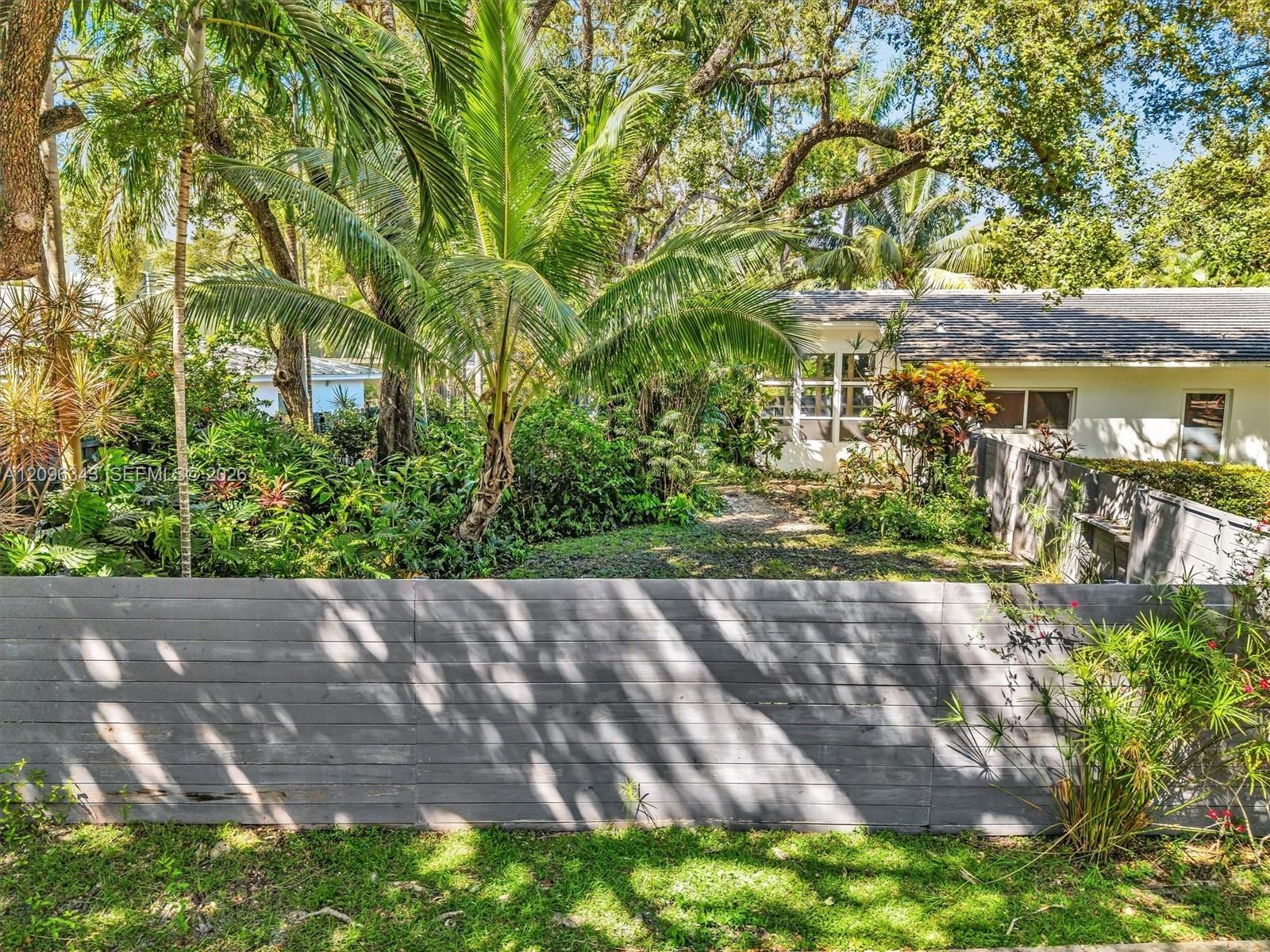 High fence all around this large yard. Great home for rent in Coconut Grove in Miami, FL.