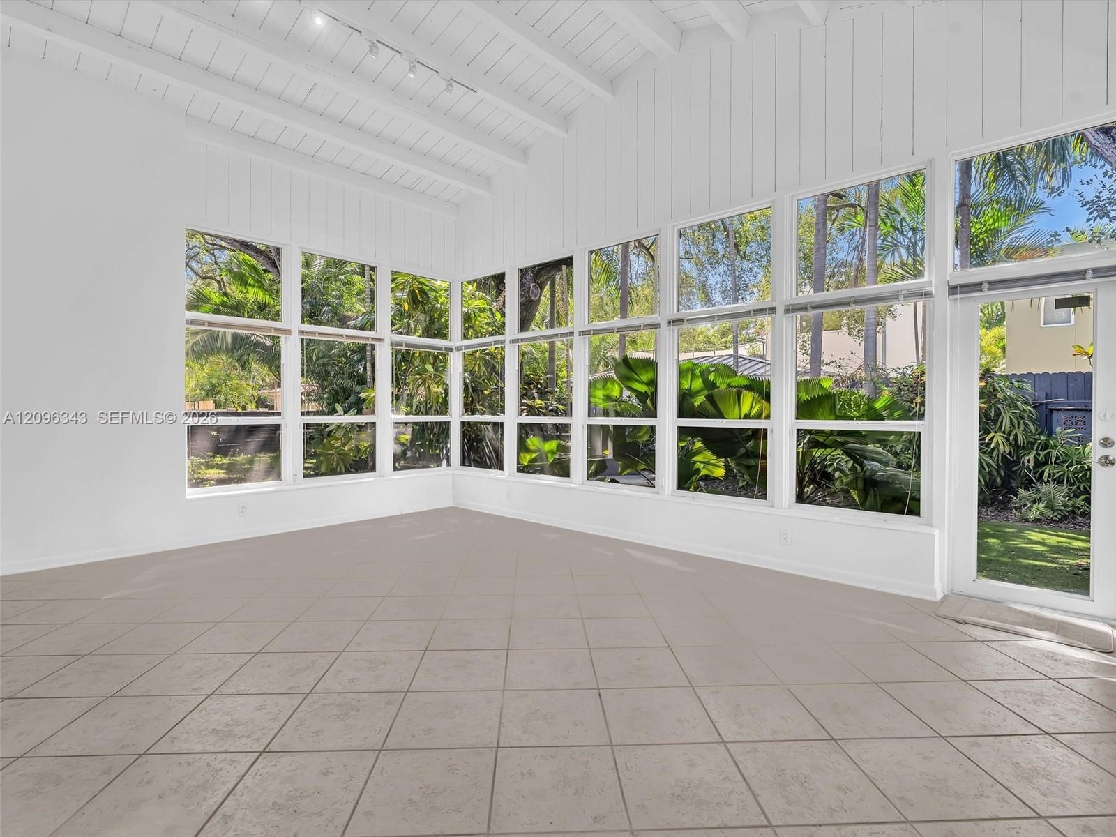 Sunny and private florida room surrounded by nature. Great home for rent in Coconut Grove in Miami, FL. Enjoy large fenced yard, updated home in the N