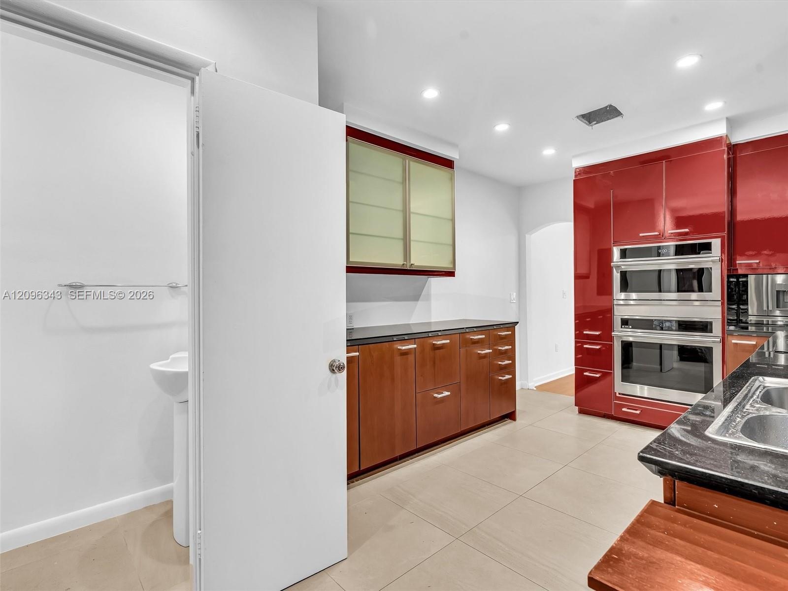 Stylish Poggenpohl kitchen with stainless steel appliances in home for rent in Coconut Grove in Miami, FL. Also showing bath. Updated rental in Natoma