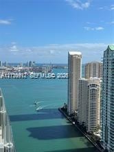 High-rise perspective featuring expansive water frontage and urban skyline scenery