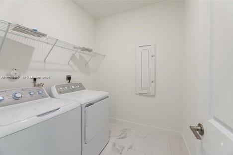 Utility area featuring white-finish tile flooring, wall-mounted wire shelving, and a recessed electrical panel