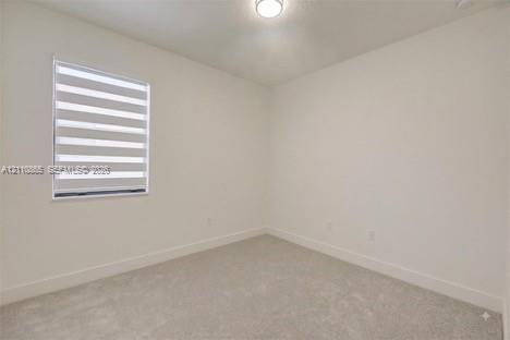 Neutral-toned wall paint, plush carpeting, ceiling-mounted light fixture, and dual-layer privacy window shades