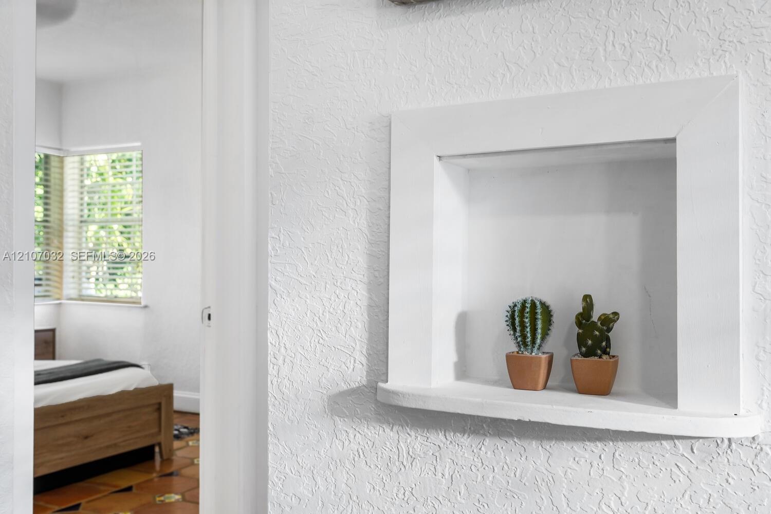 Built-in wall niche with a curved shelf and textured wall finish