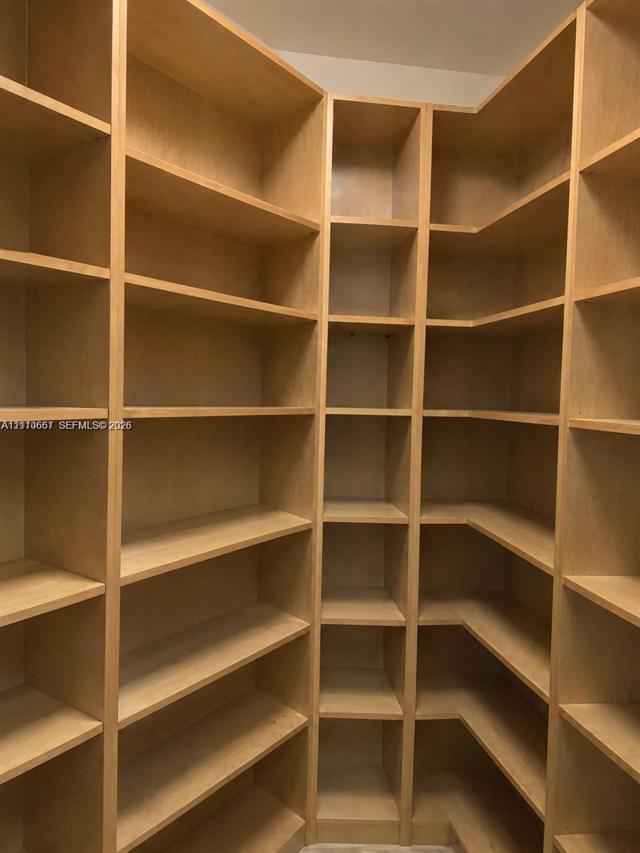 Floor-to-ceiling wooden shelving with a custom L-shaped configuration