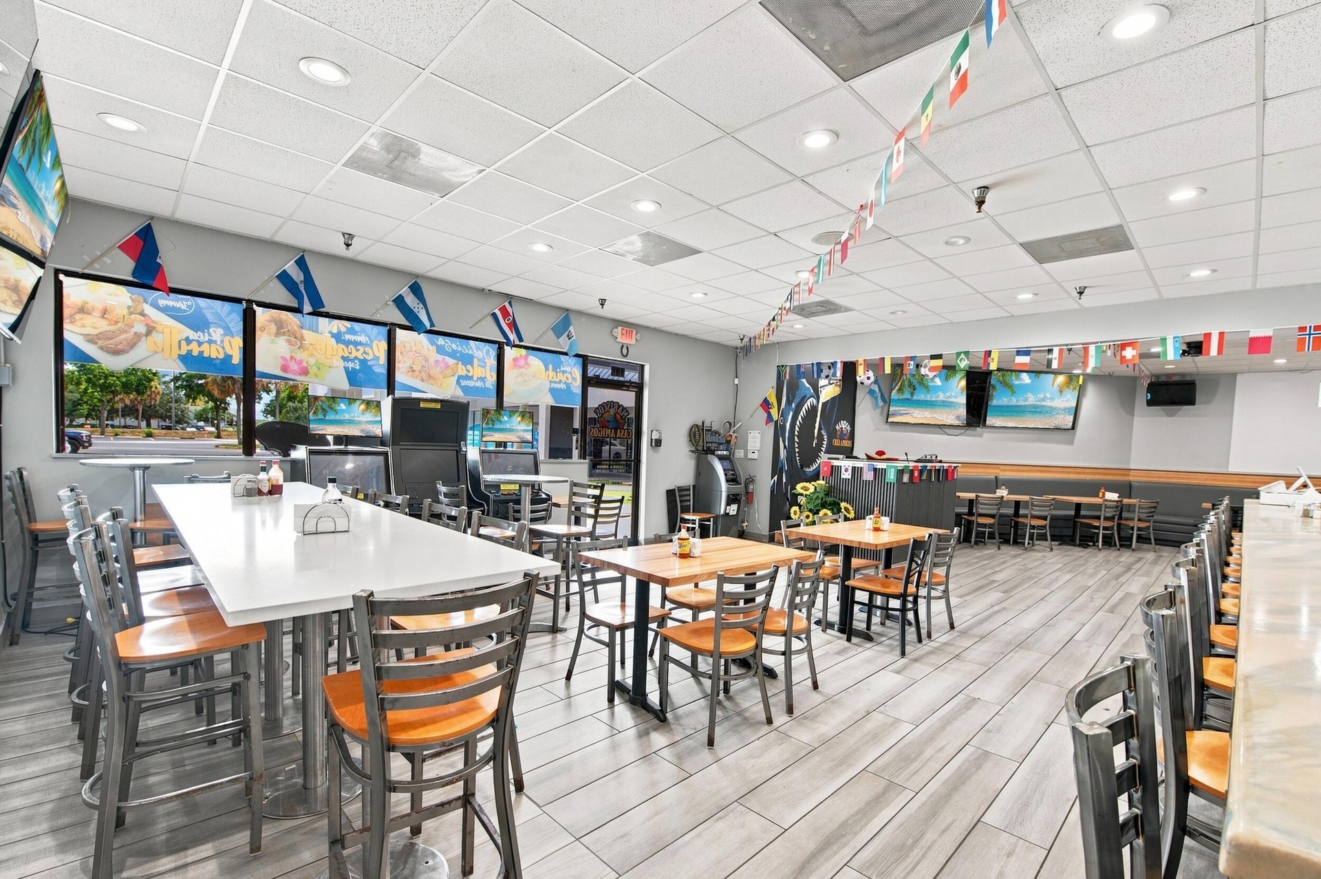Spacious interior featuring wood-finish flooring, recessed lighting, and multiple large windows