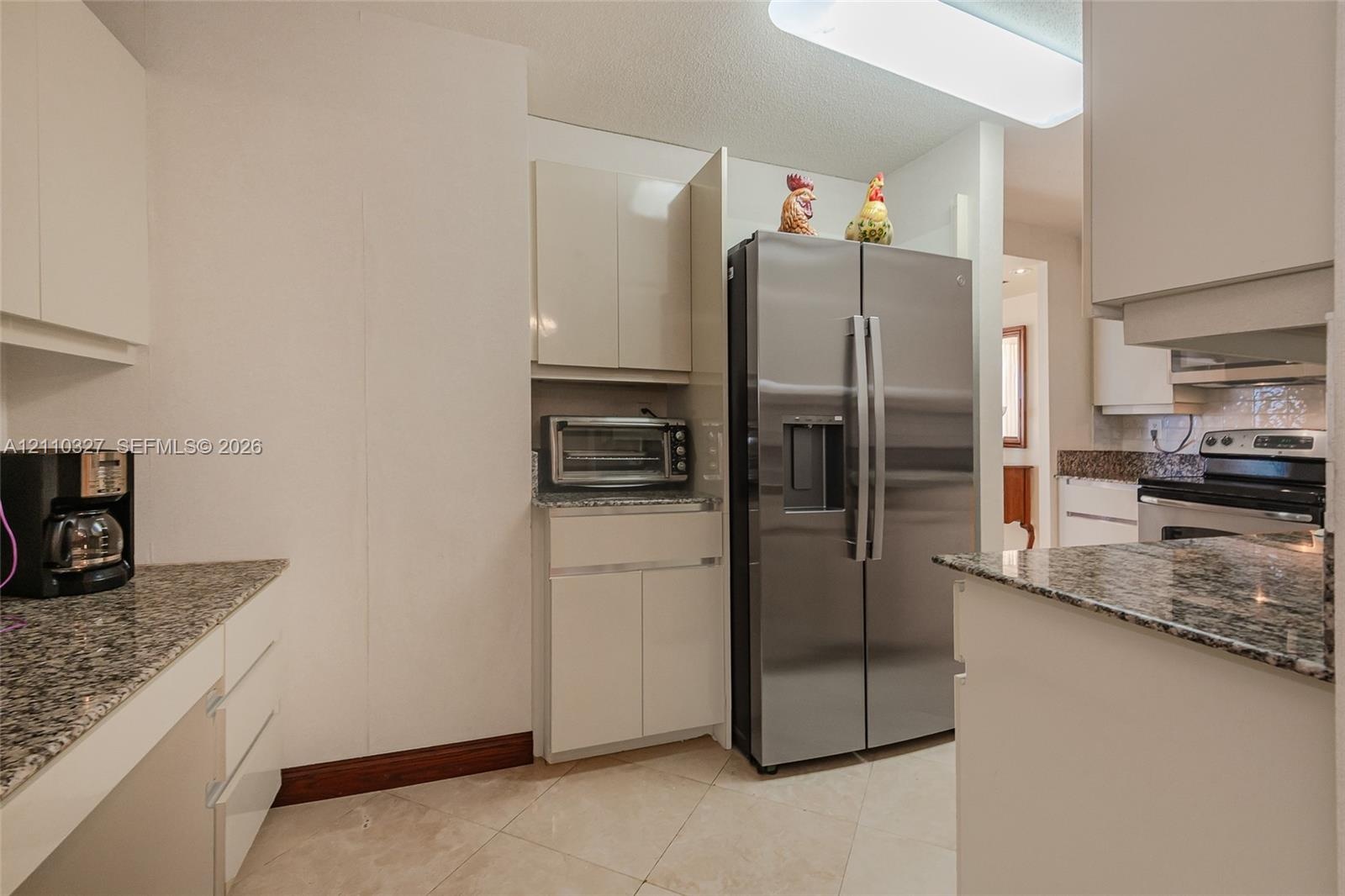 Wood-finish flooring, sliding glass balcony doors, and prominent ocean exposure