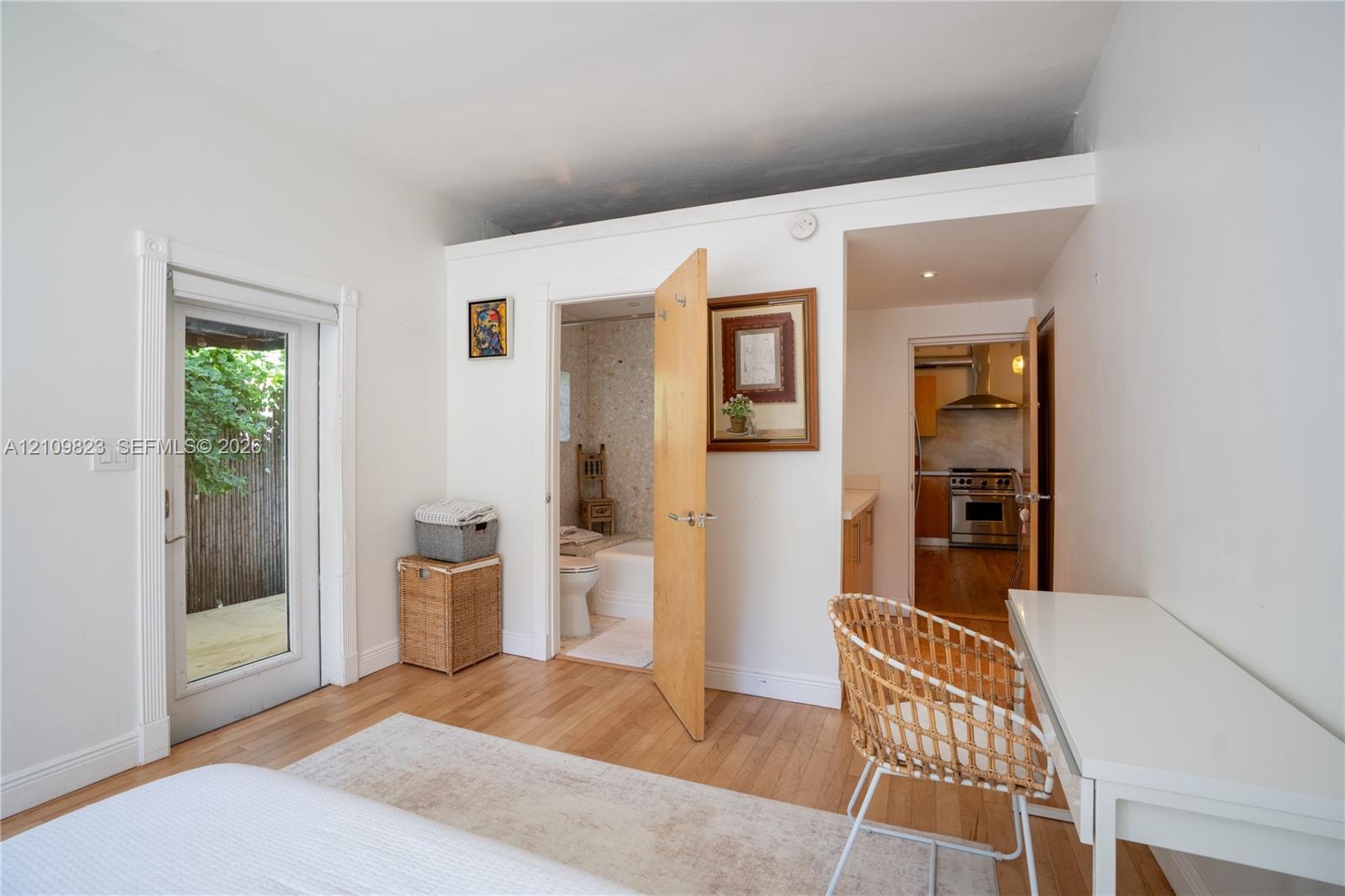 Wood-finish flooring, glass-paneled exterior door, and solid core interior door