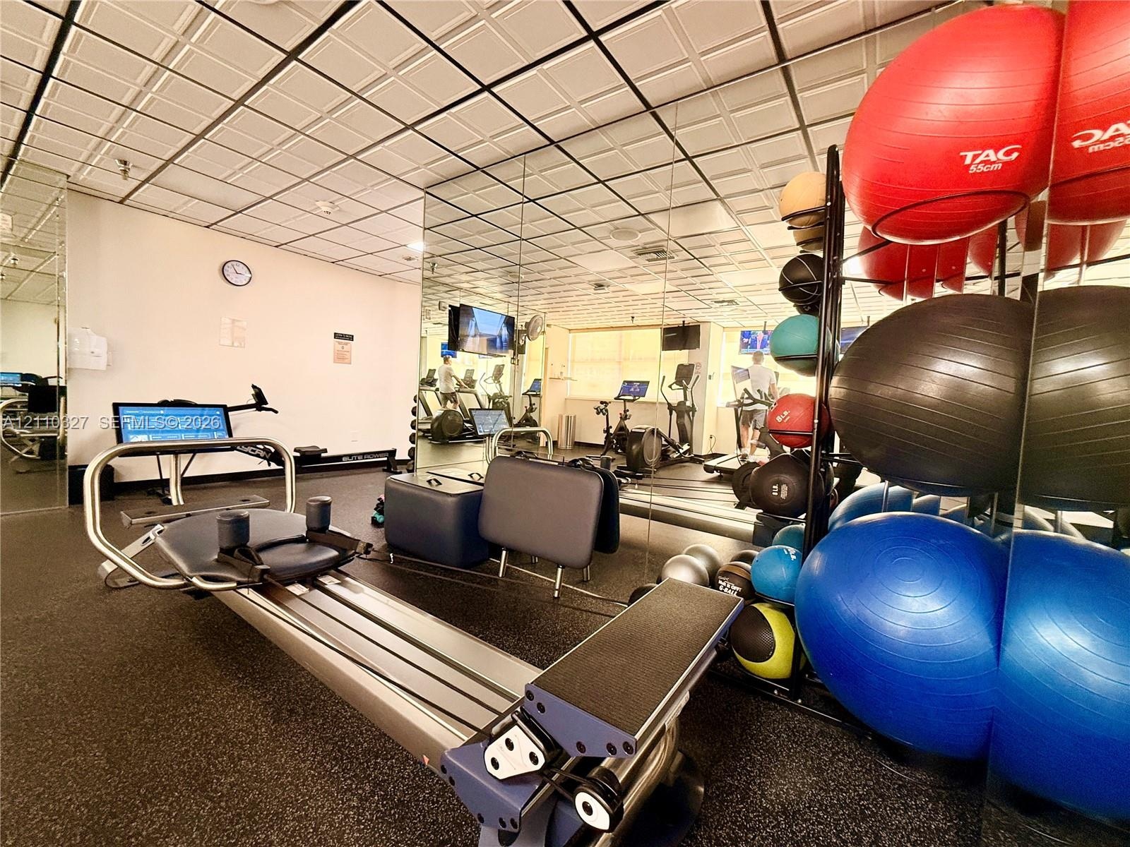 Flexible interior room featuring durable speckled flooring, recessed lighting, and wall-mounted shelving