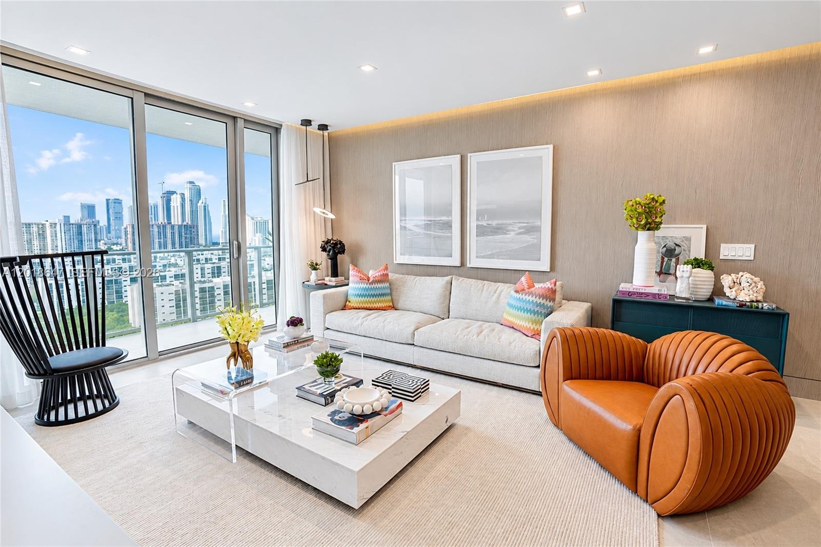 Textured wall paneling, floor-to-ceiling glass sliding door, recessed ceiling lighting, and polished stone tile flooring