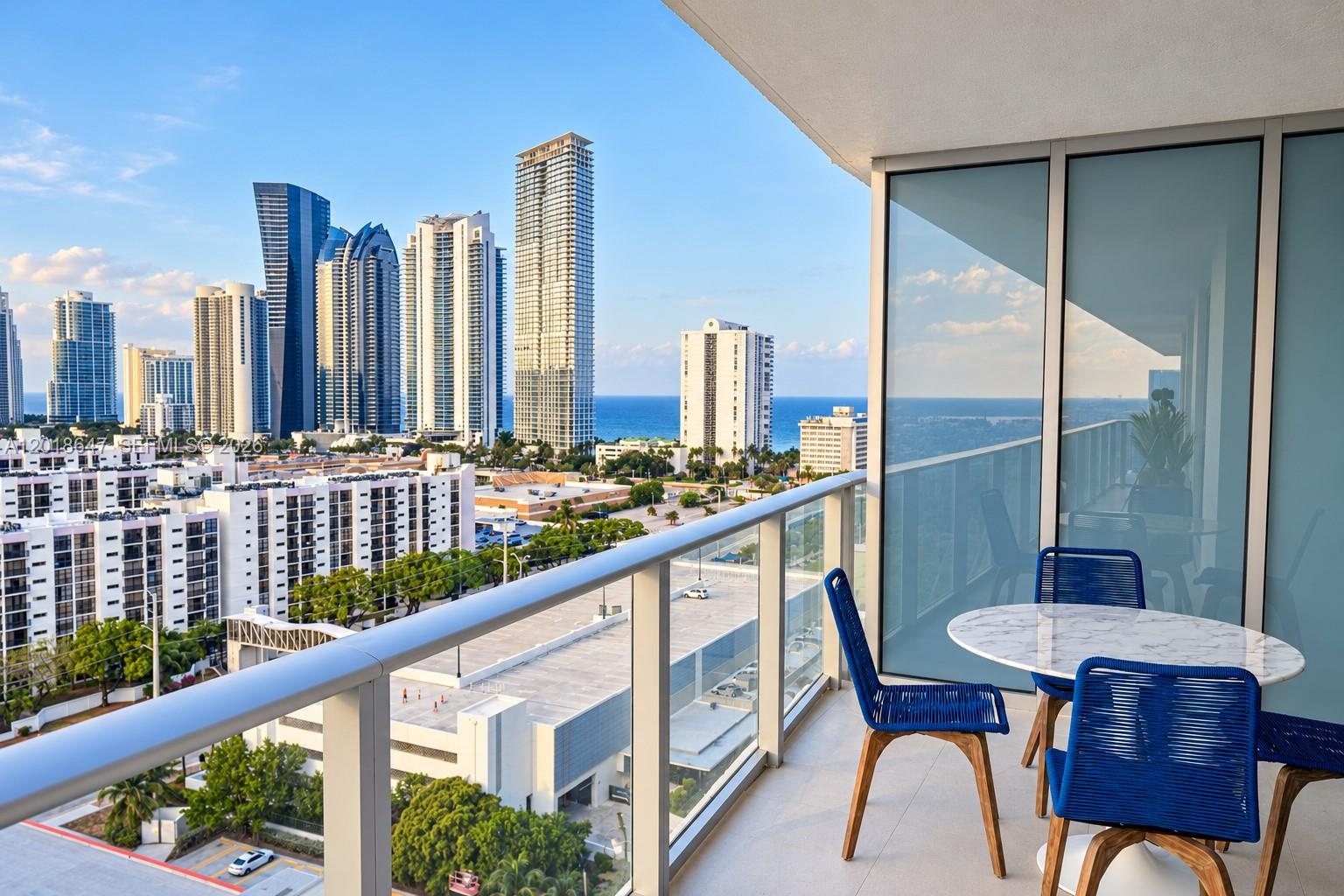 High-rise residential building featuring floor-to-ceiling glass windows, a rooftop pool, private balconies, and waterfront positioning
