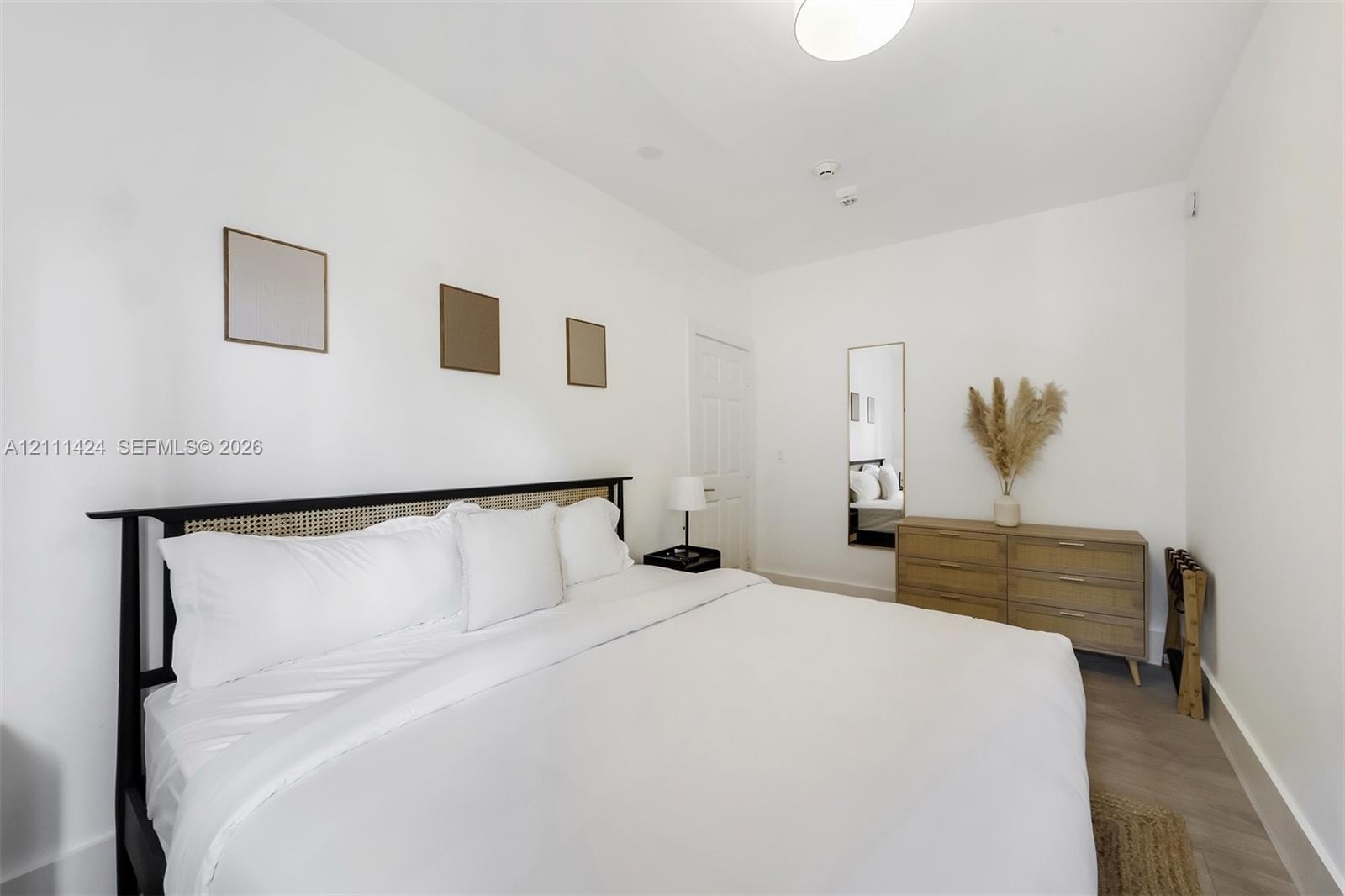 Neutral walls, wood-finish flooring, and recessed ceiling lighting