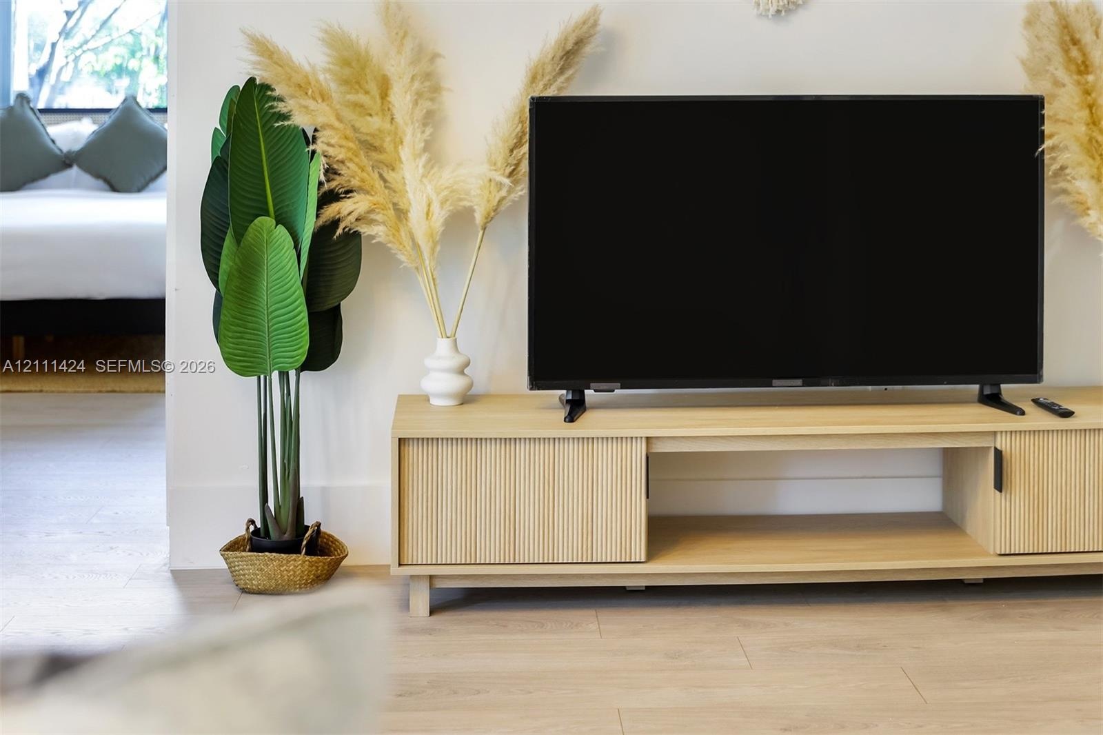 Light-toned wood-finish flooring throughout