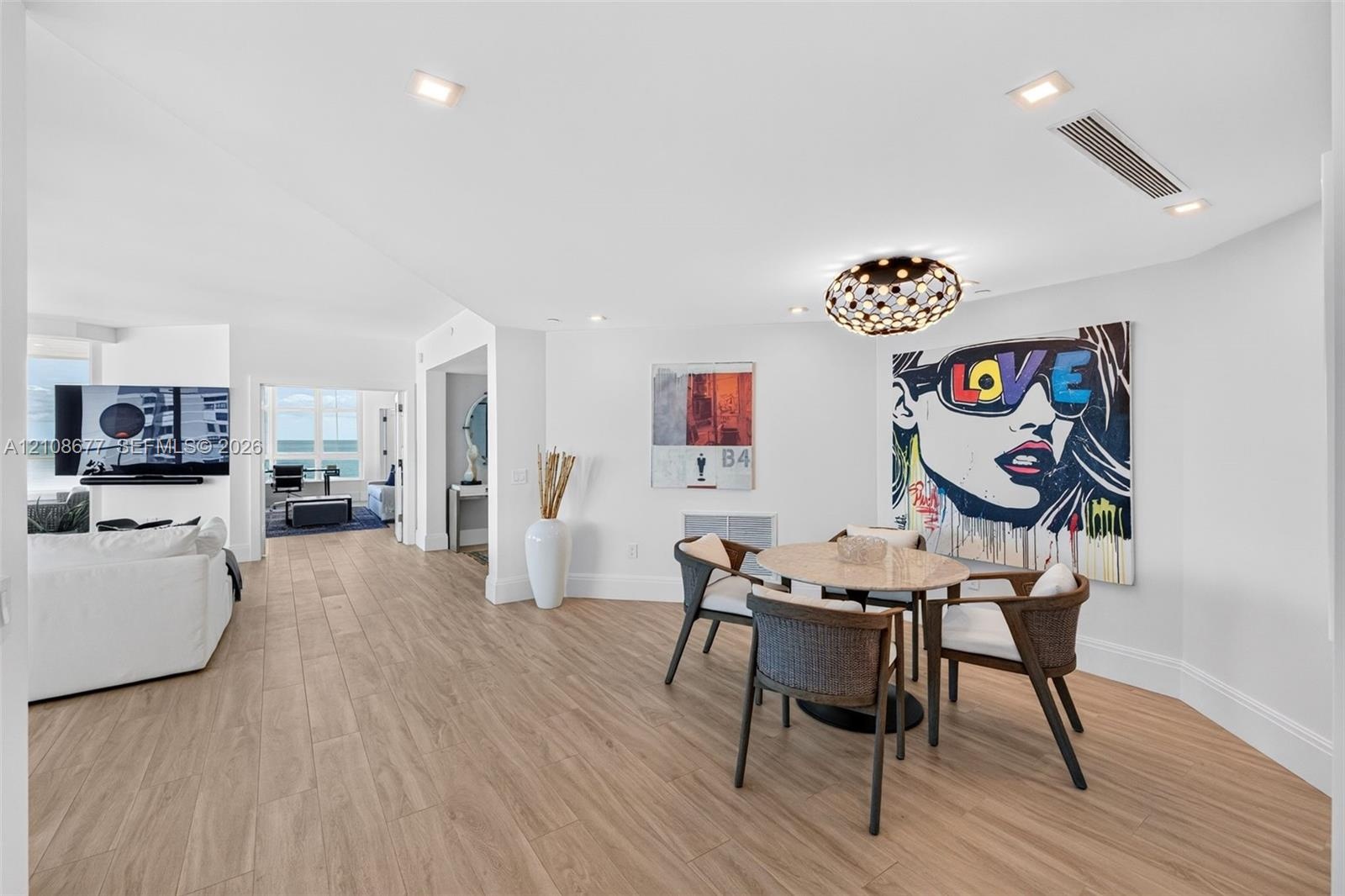 Open-concept dining nook area (can also be a space for an office) featuring porcelain flooring, recessed lighting, and a modern beautiful tiered-orb f