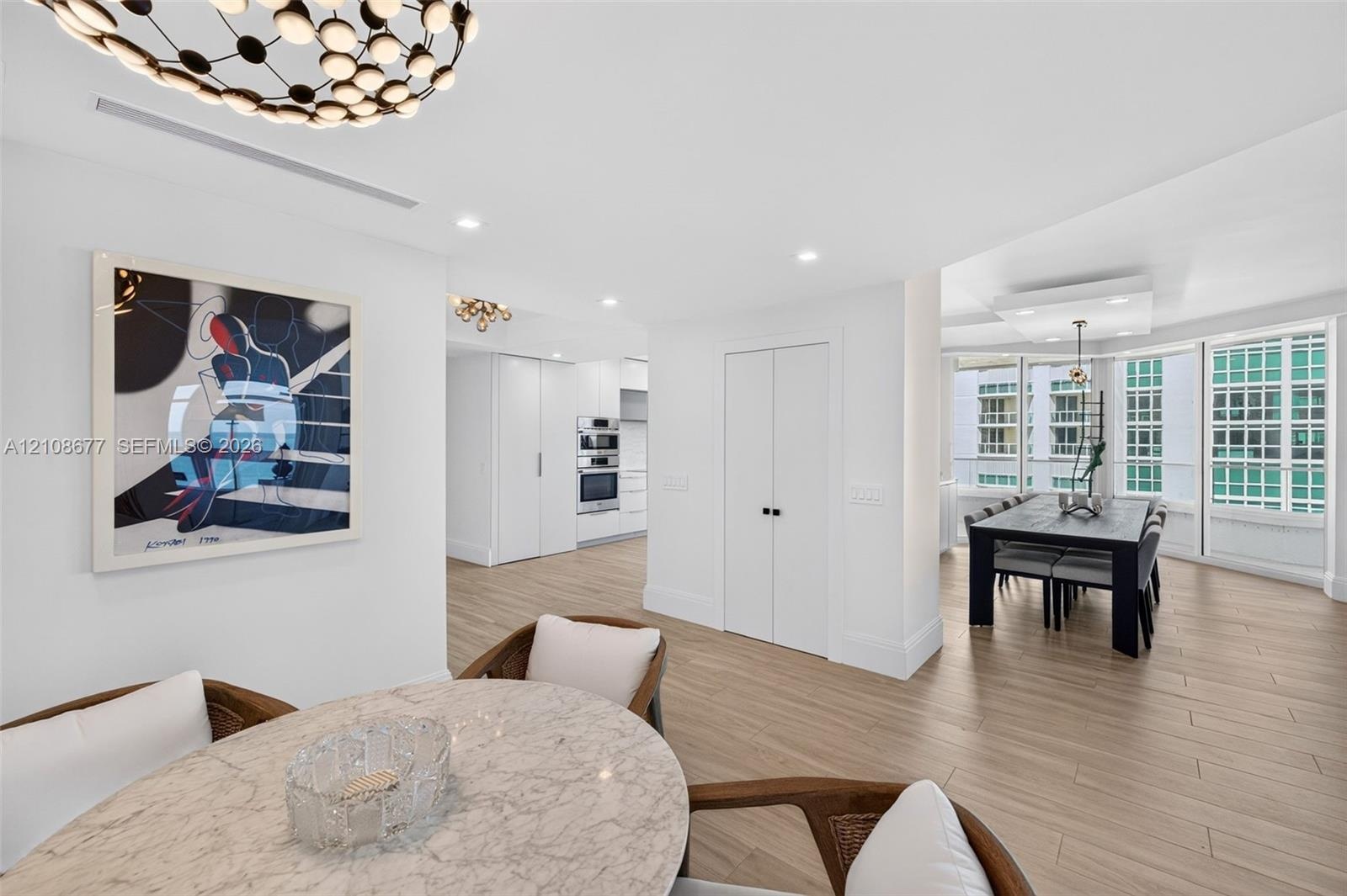 Wood look plank porcelain flooring, recessed lighting, double-door closet / pantry storage, built-in double wall oven, and floor to ceiling windows / 