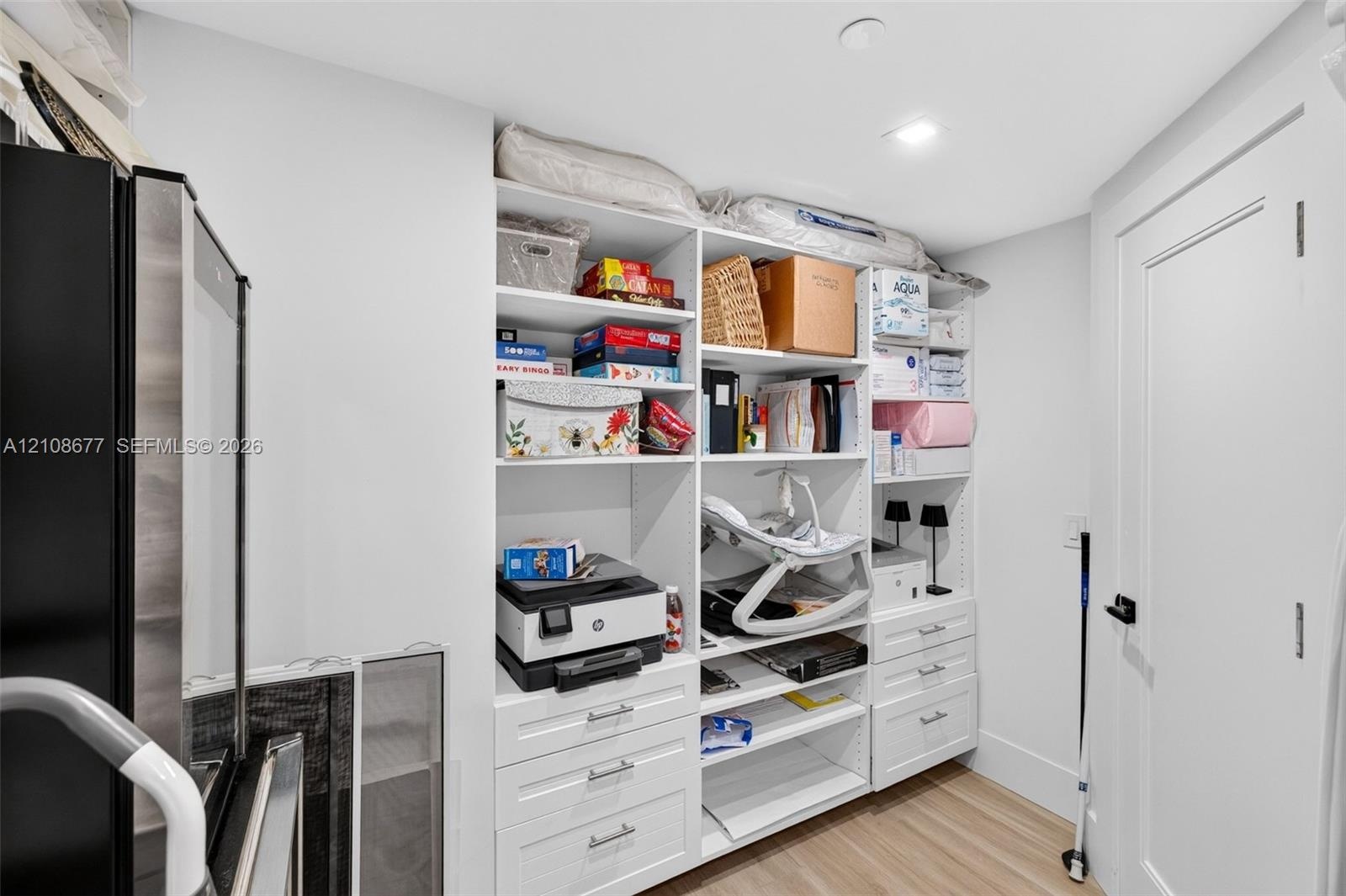 One angle of the walk in closet off bedroom #3 w/ custom built ins. Closet is very large wraps around into a large L shape