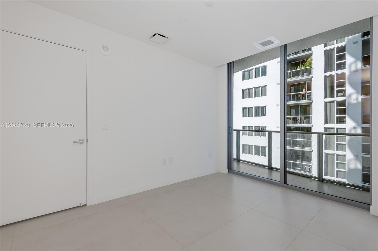 second bedroom and a sliding glass door opening to a private balcony.