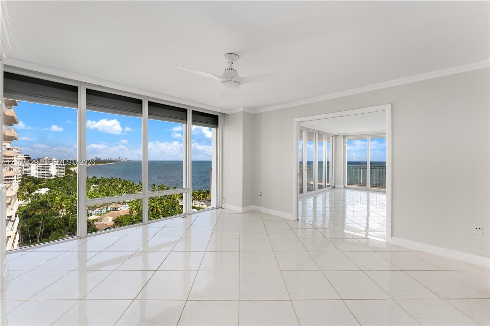 Floor-to-ceiling windows, white tile flooring, ceiling fan, and crown molding