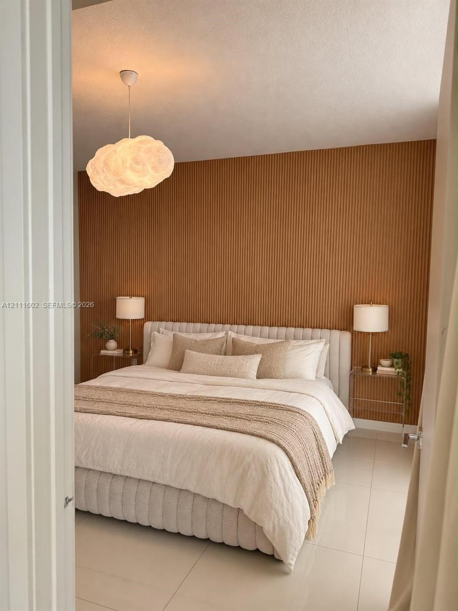 Vertical wood-slat accent wall, tile flooring, and sculptural cloud-shaped pendant lighting