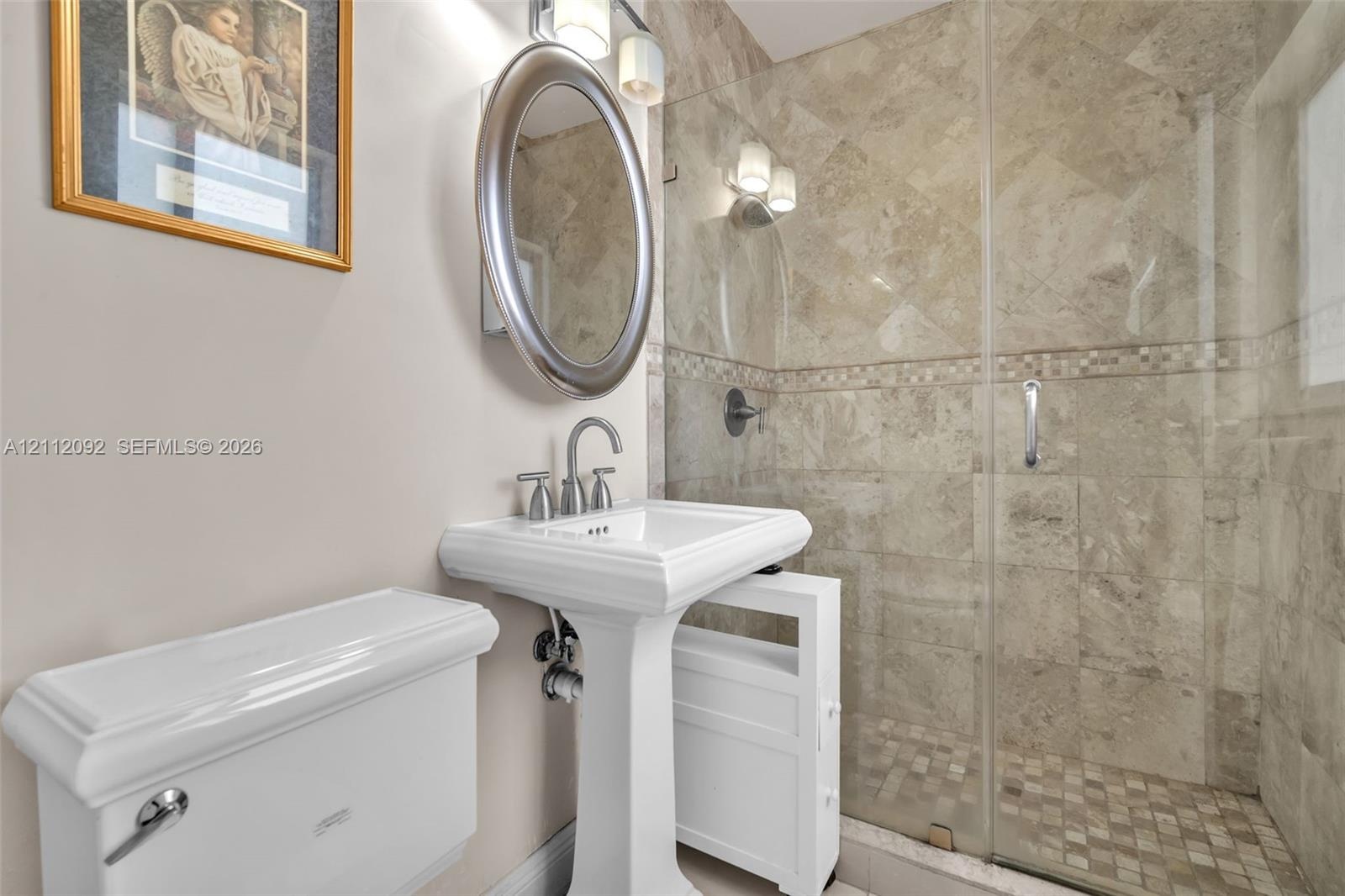 Neutral-toned tile flooring, crown molding, and dual windows equipped with horizontal blinds