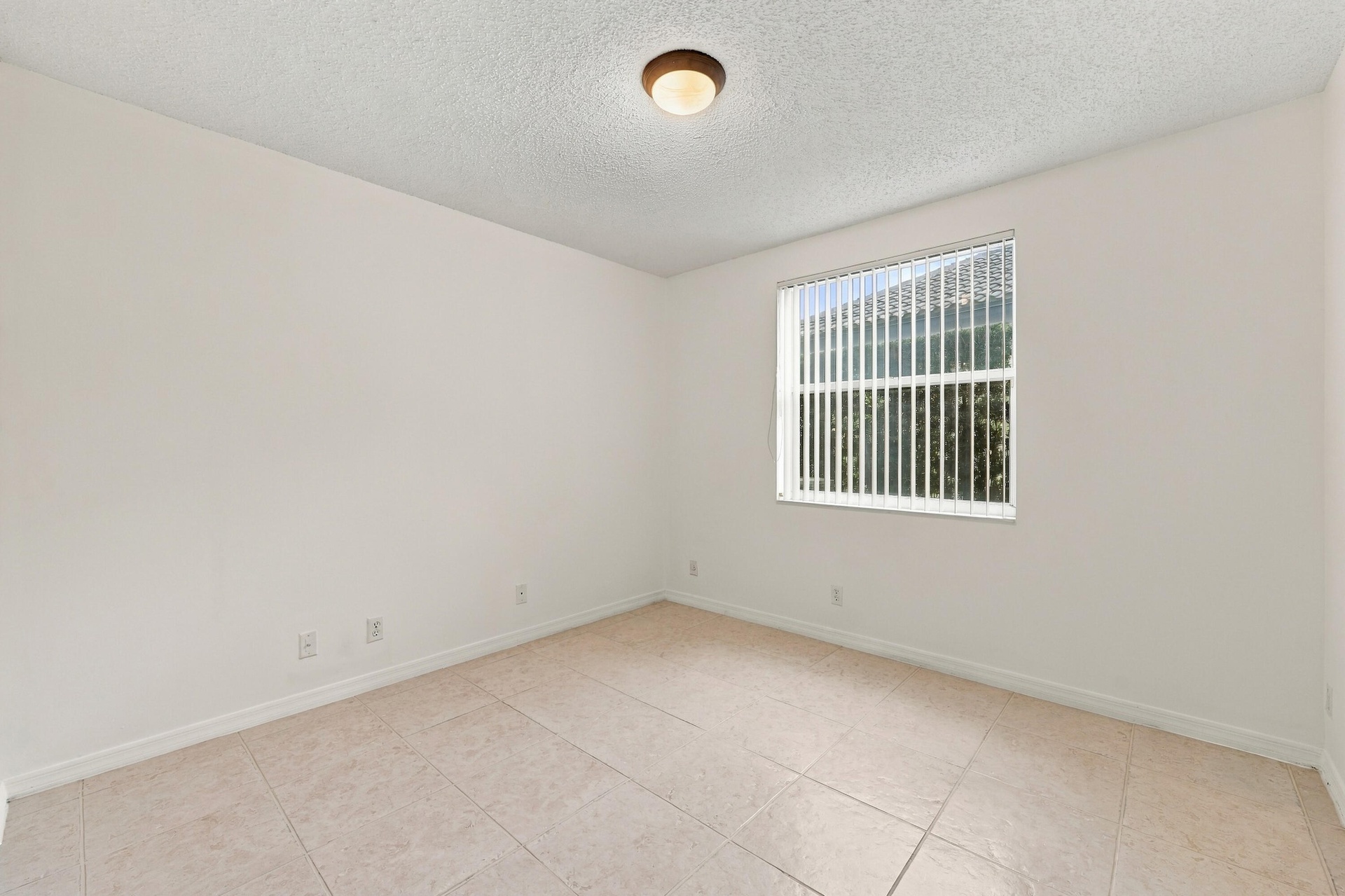 This well-appointed main-level bedroom offers flexibility for guests, a private office, or additional living space, with convenient access to the home