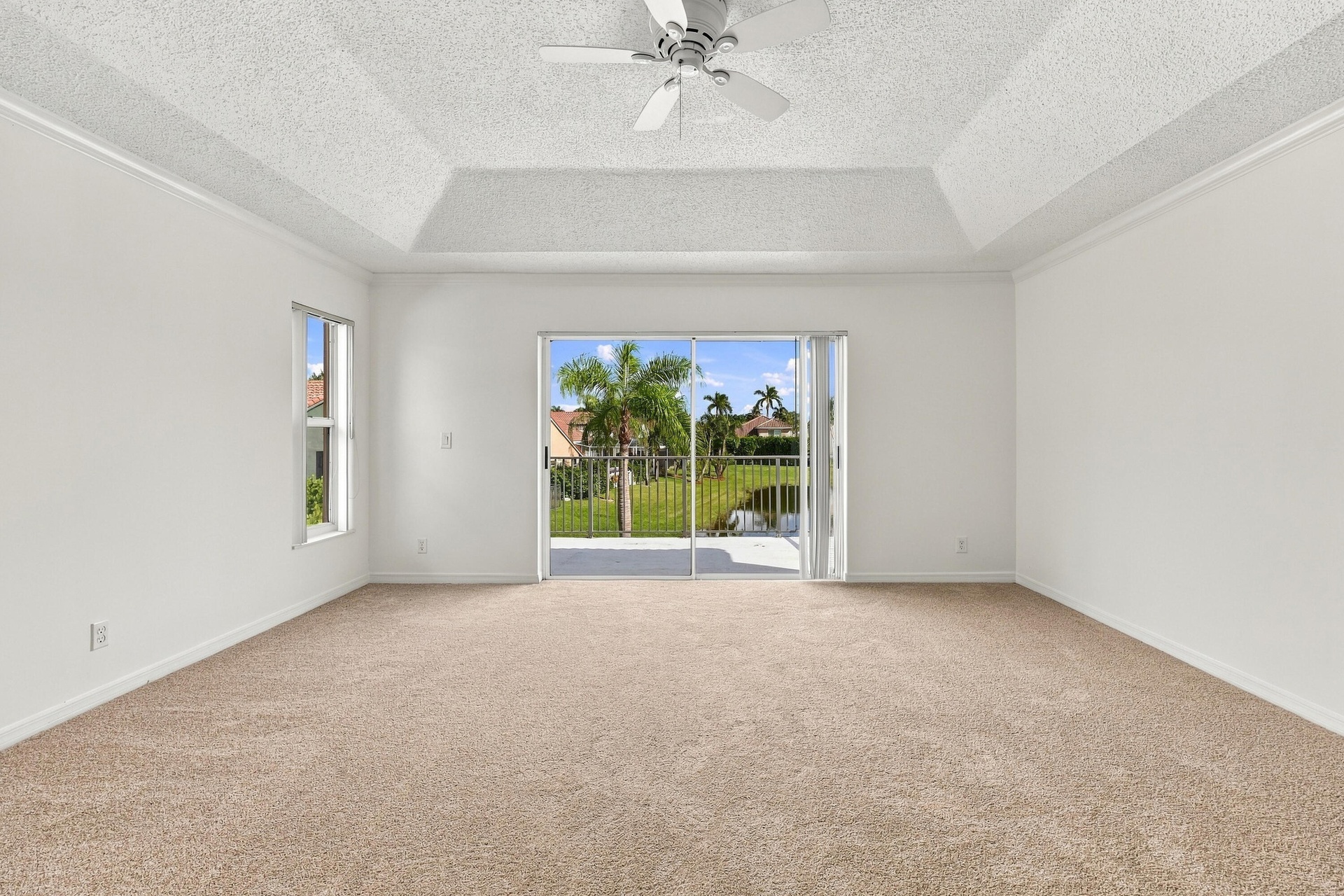 Wake up to beautiful waterfront views! Sliding glass doors open directly onto a private second-story balcony overlooking the tranquil lake and tropica