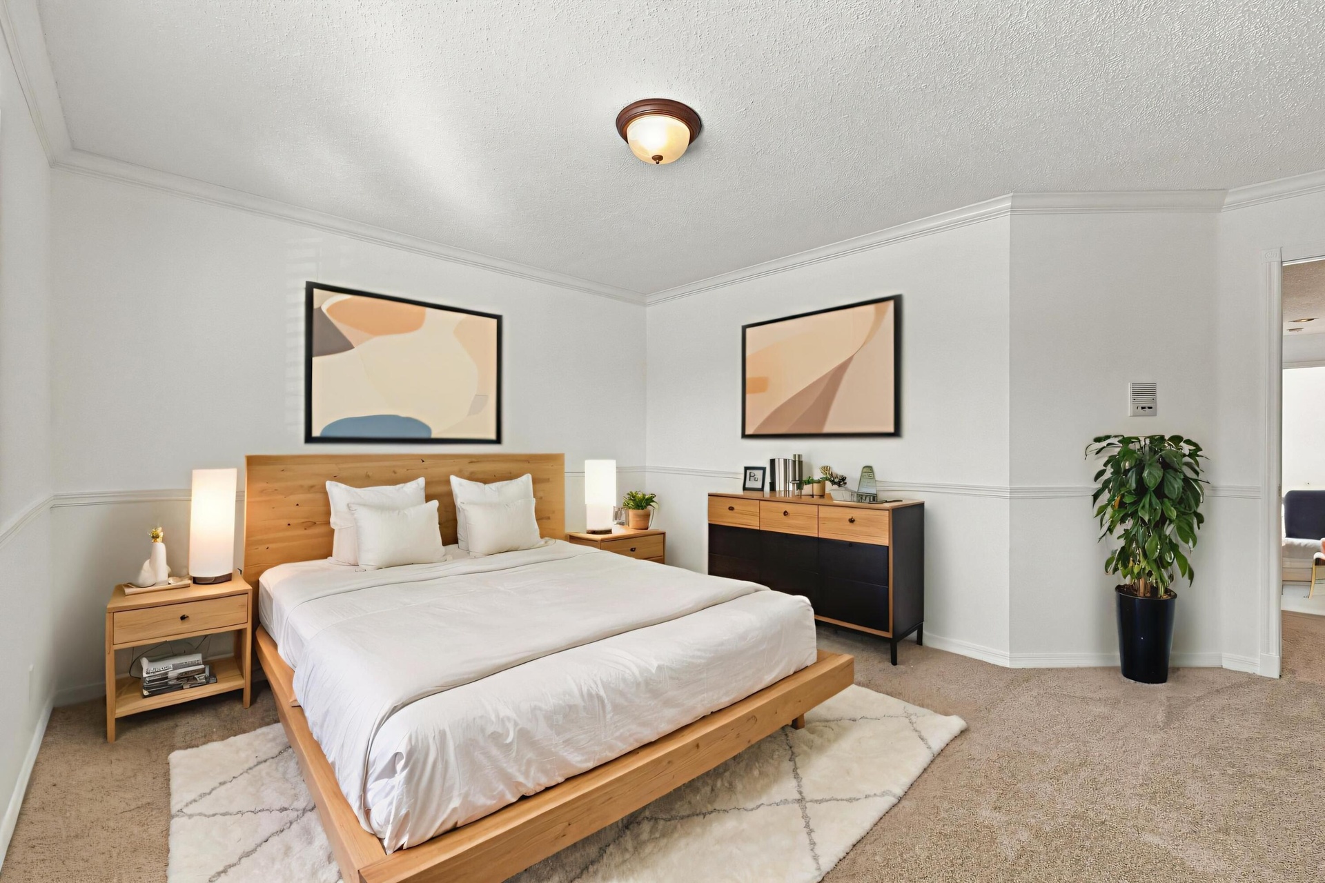 With its generous proportions, neutral carpeting, and decorative wall details, this bedroom offers flexibility for guests, family, or a home office.