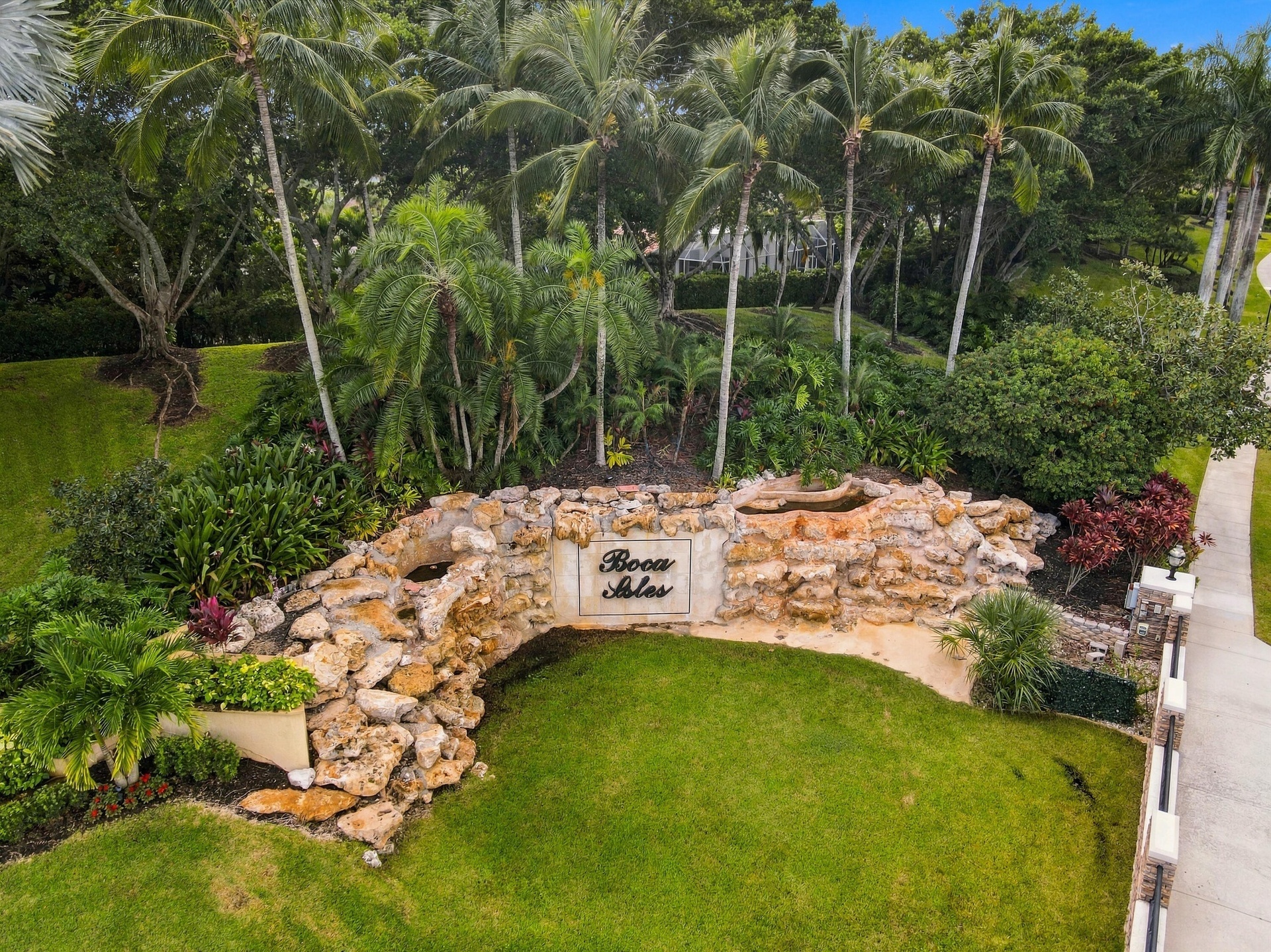 Discover the beautifully landscaped entrance to Boca Isles South, a sought-after Boca Raton community offering an exceptional collection of amenities 