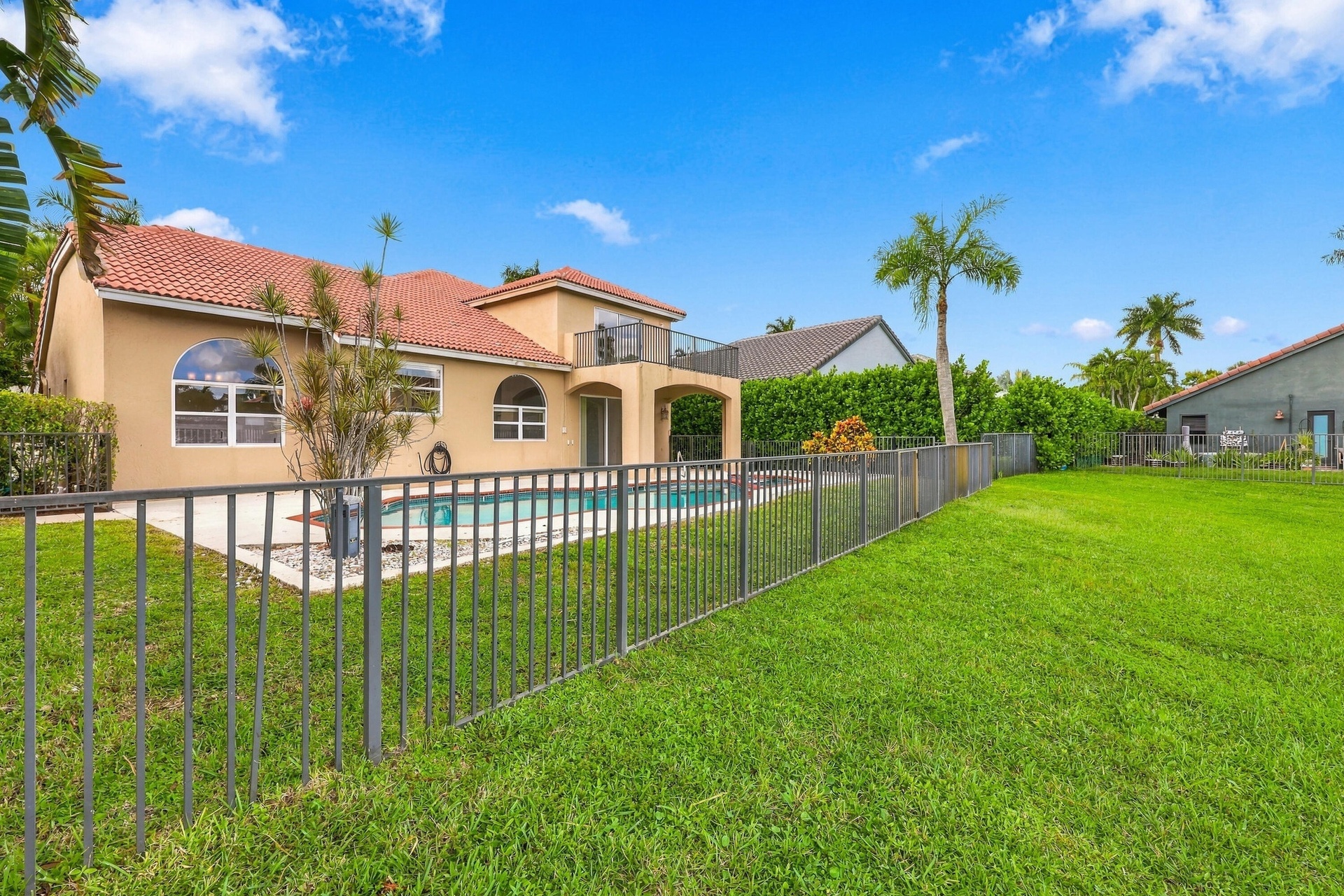 Privacy meets paradise! The fully fenced pool area, tropical landscaping, and peaceful waterfront setting offer the perfect combination of relaxation 