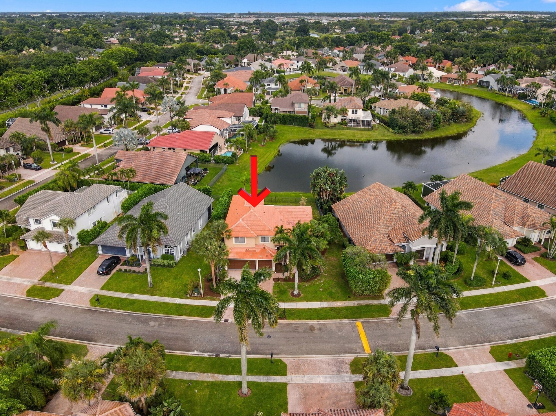 An elevated perspective highlighting the home's beautiful waterfront location within the desirable Boca Isles South community.