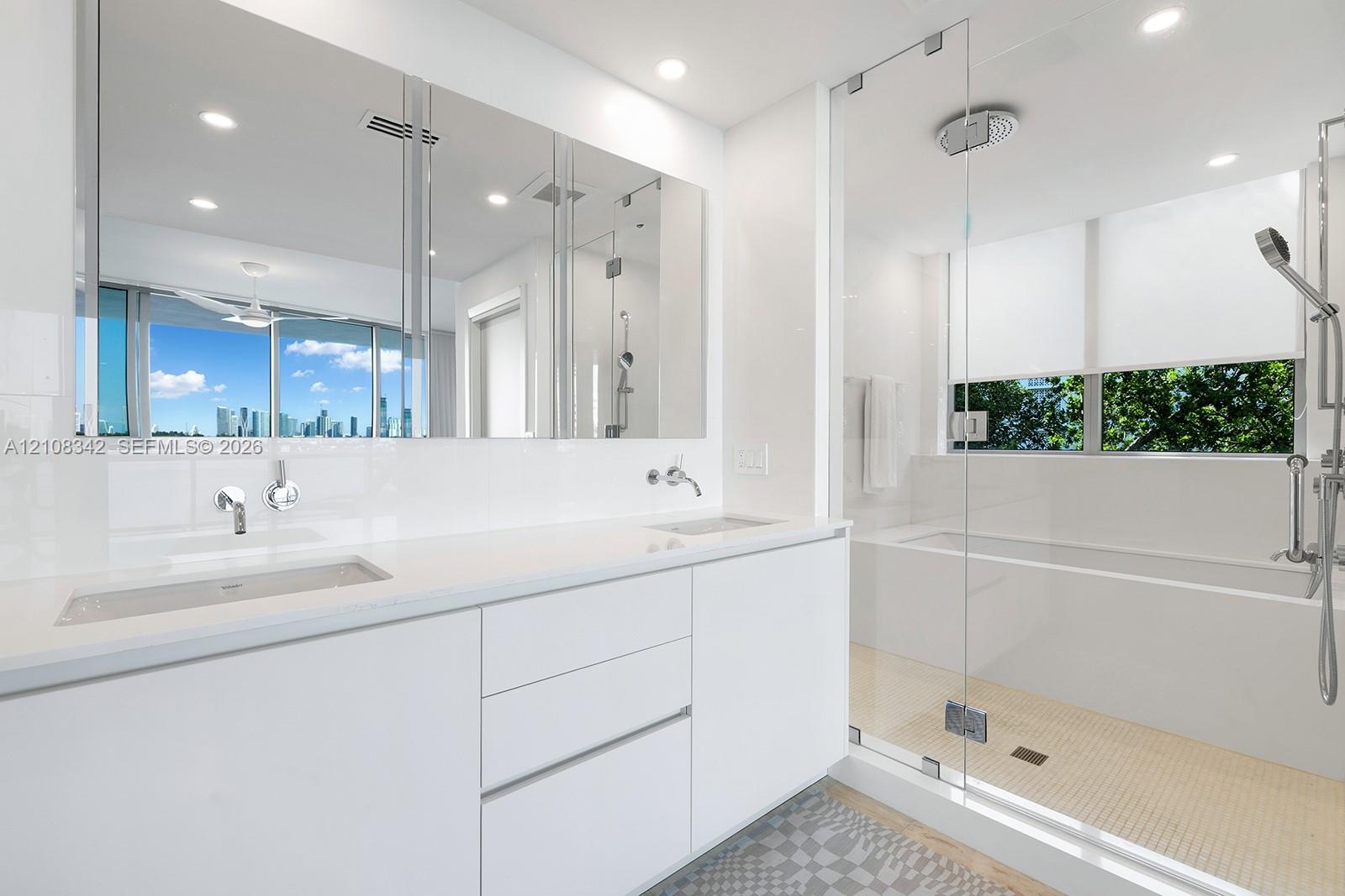 Floating dual-sink vanity with a solid surface countertop, large wall-to-wall mirror, glass-enclosed walk-in shower, built-in soaking tub, and recesse