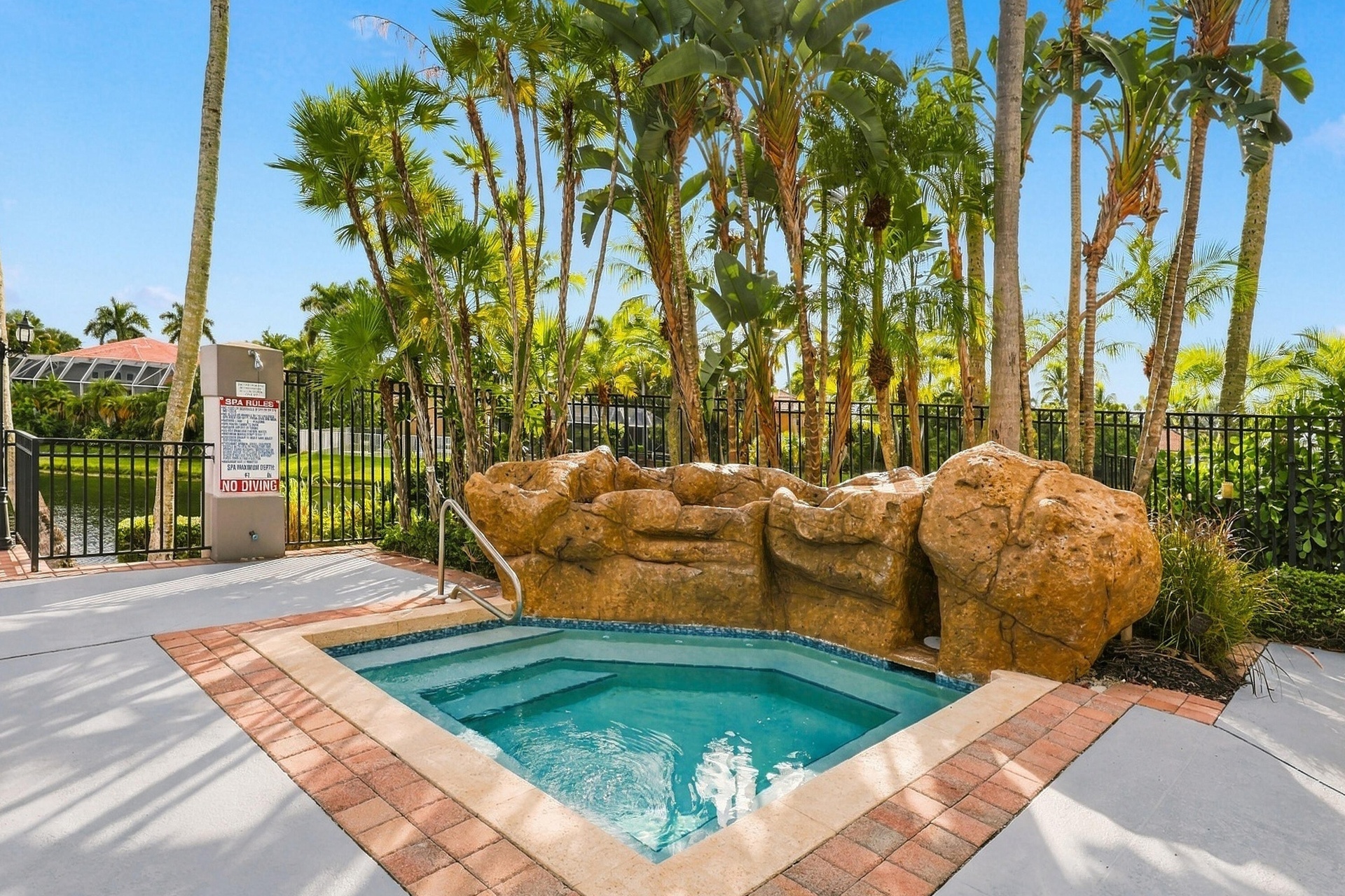 Unwind in the community spa, surrounded by natural rock features and tropical landscaping, offering a relaxing retreat just moments from home.