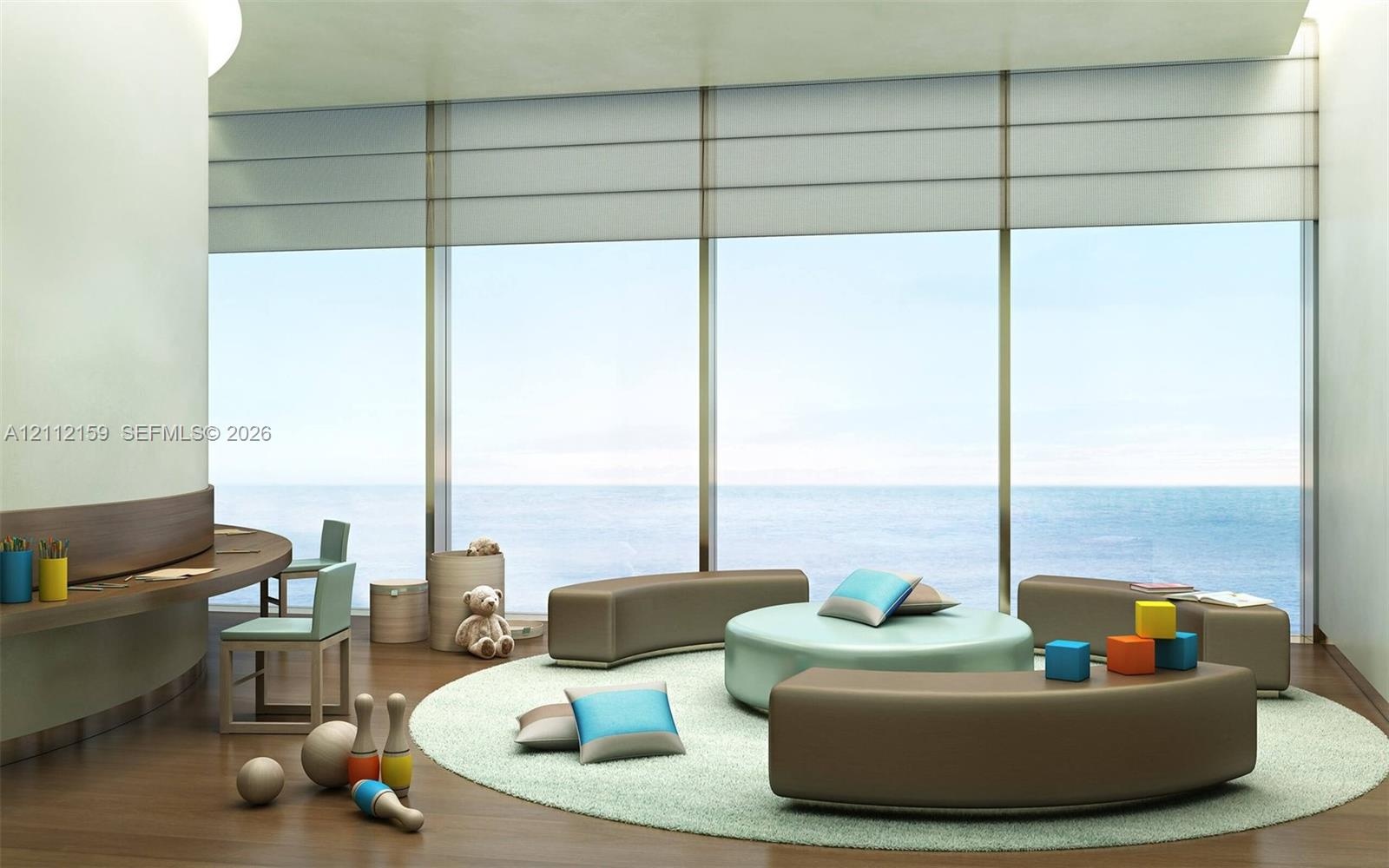 Floor-to-ceiling windows featuring ocean scenery, curved architectural wall, built-in wooden desk, and wood-finish flooring