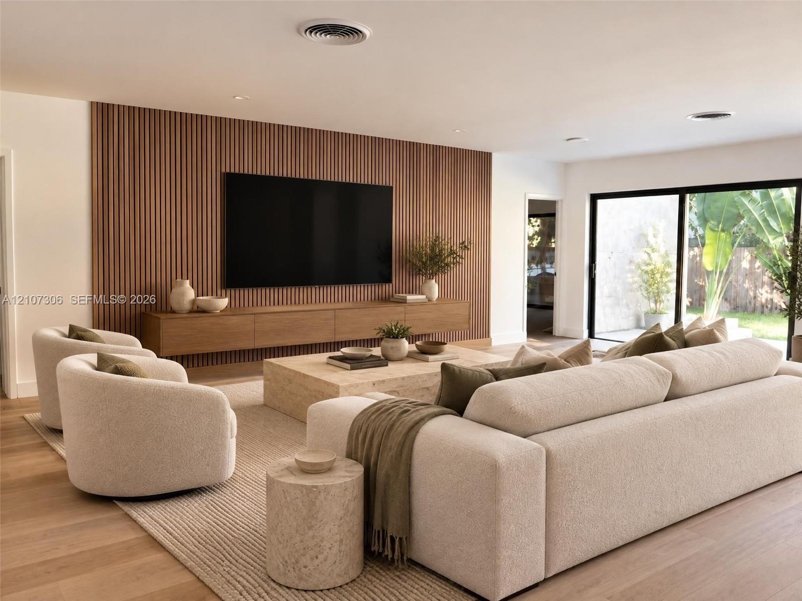 Vertical slat wood feature wall with a built-in wall-mounted media console, wood-finish flooring, and expansive sliding glass doors