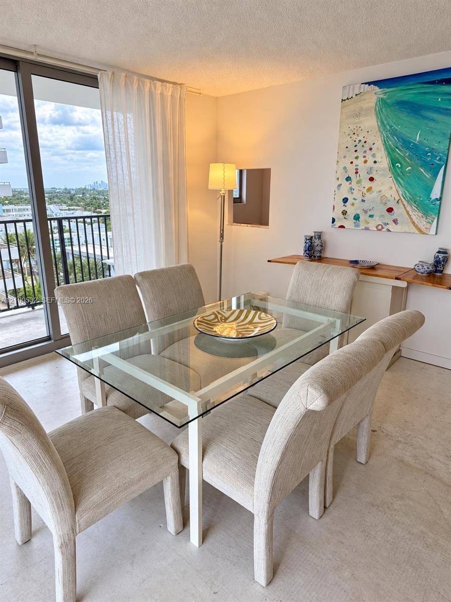 Full-height glass sliding doors, private exterior balcony with metal railing, and recessed wall niche
