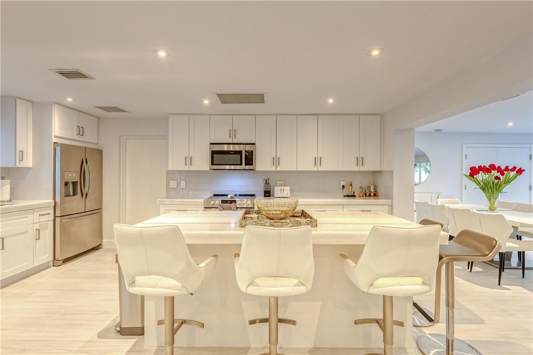 Marble Island bar with 5 barstools and expansive chef's kitchen.
