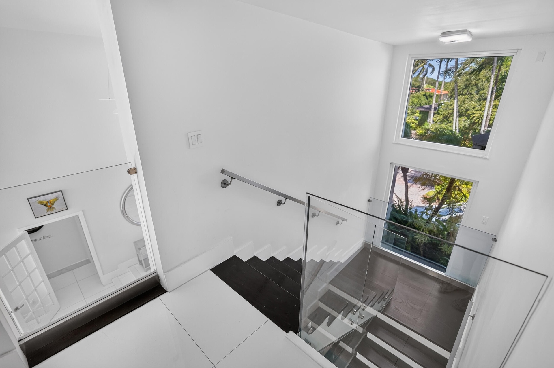 GLASS RAIL OVERLOOKING THE LIVING ROOM