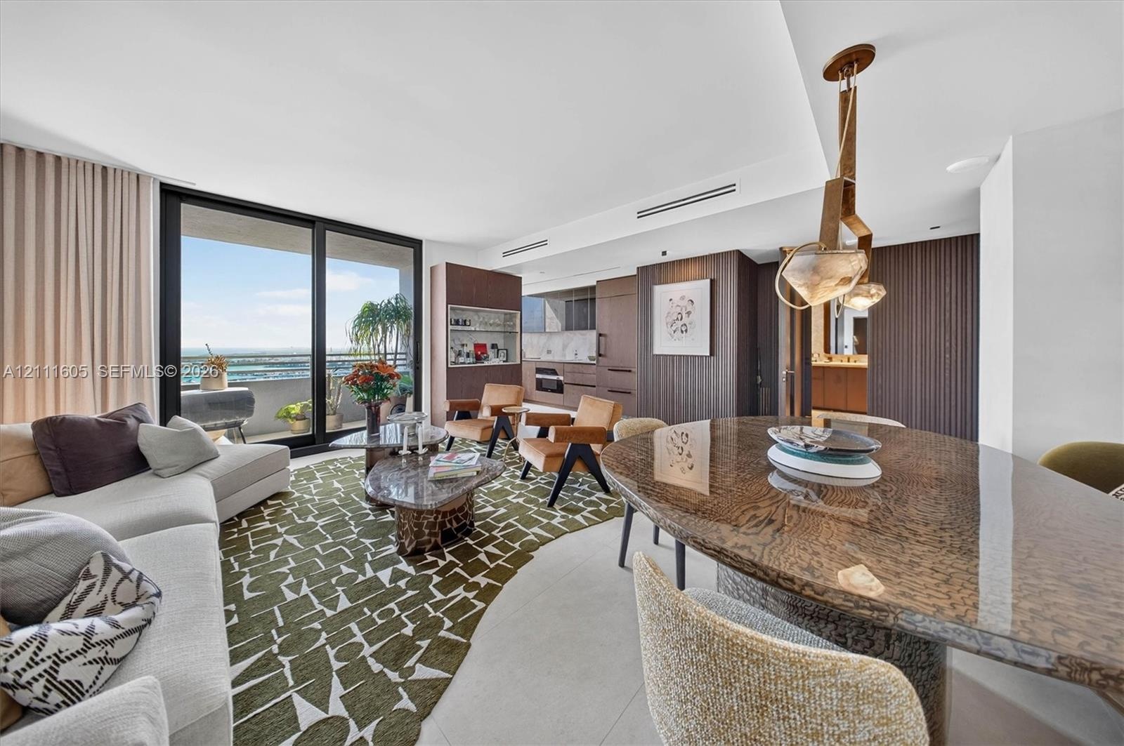 Full-height wall panels with textured light-gray finish, floor-to-ceiling mirror-finish cabinetry, porcelain tile flooring, and integrated ceiling tra