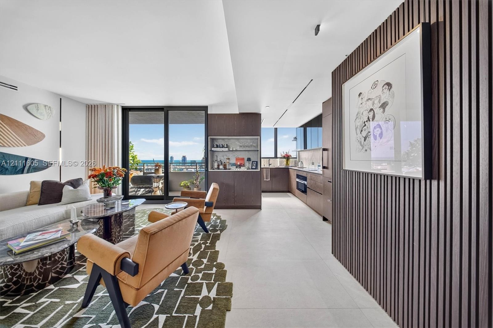 Kitchen featuring flat-panel wood-finish cabinetry, integrated appliances, stone backsplash, built-in dry bar, and large-format tile flooring