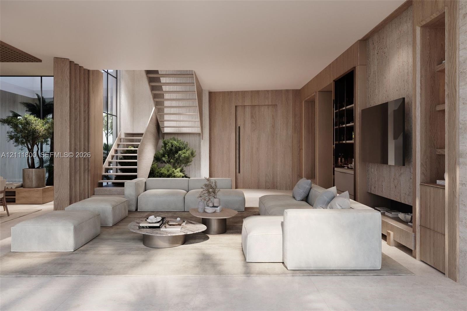 Open-concept living space featuring wood-paneled walls, floor-to-ceiling custom built-in cabinetry, an open-riser wood staircase, and expansive window