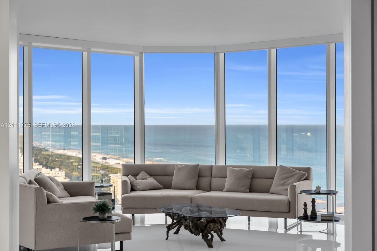 Floor-to-ceiling panoramic windows featuring expansive ocean and coastal scenery
