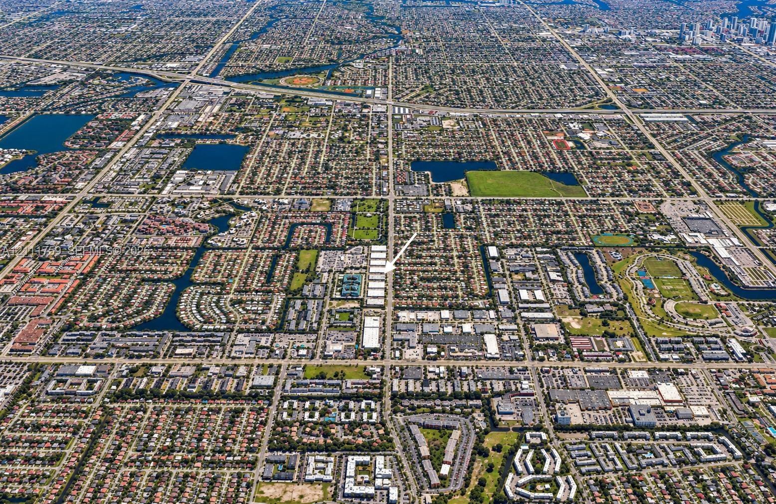 Aerial perspective featuring a gridded urban layout, established residential density, integrated waterway systems, and proximity to regional commercia