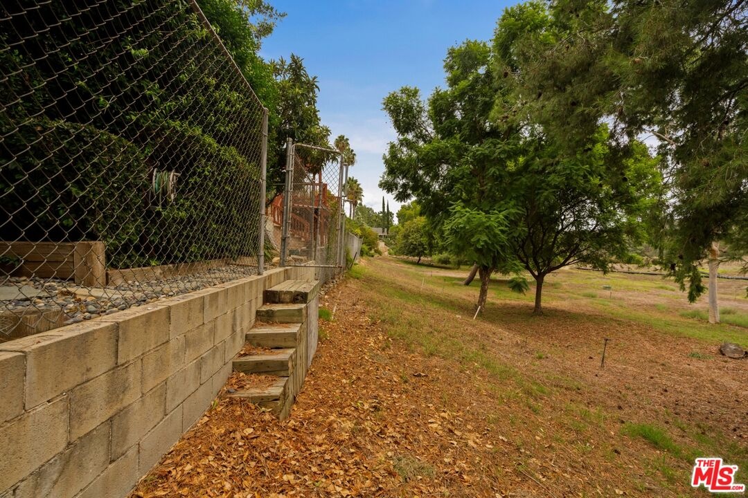 Steps down to city owned open 