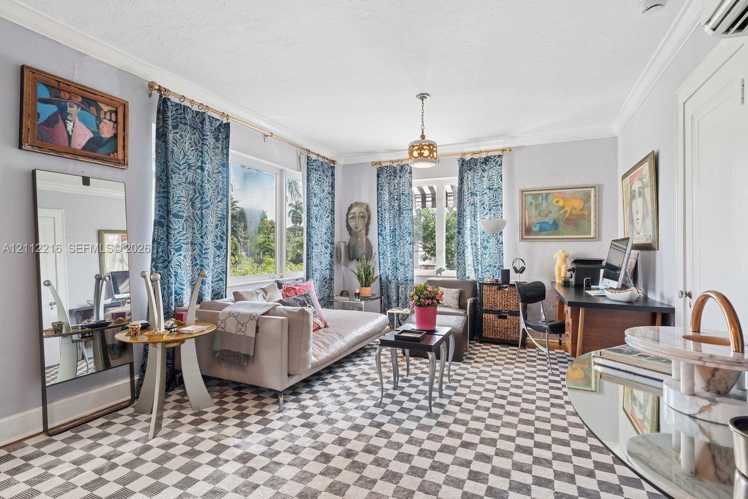 Living space featuring crown molding, multiple windows with decorative brass curtain rods, checkered tile flooring, and a central pendant light fixtur