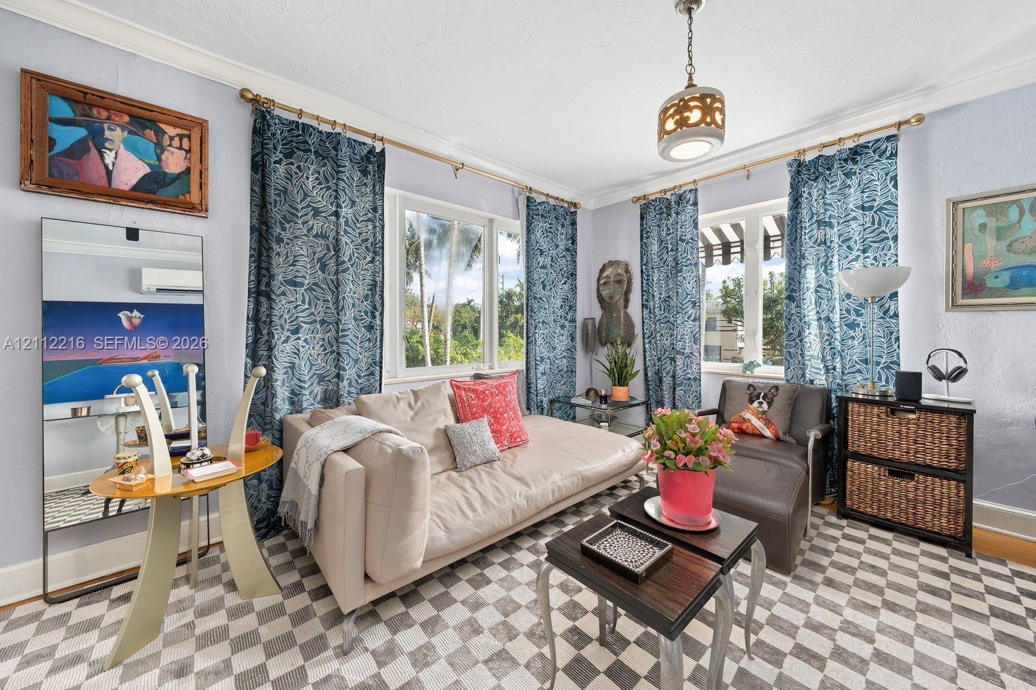 Multi-pane windows, crown molding, wall-mounted ductless climate control system, and a decorative ceiling-mounted light fixture