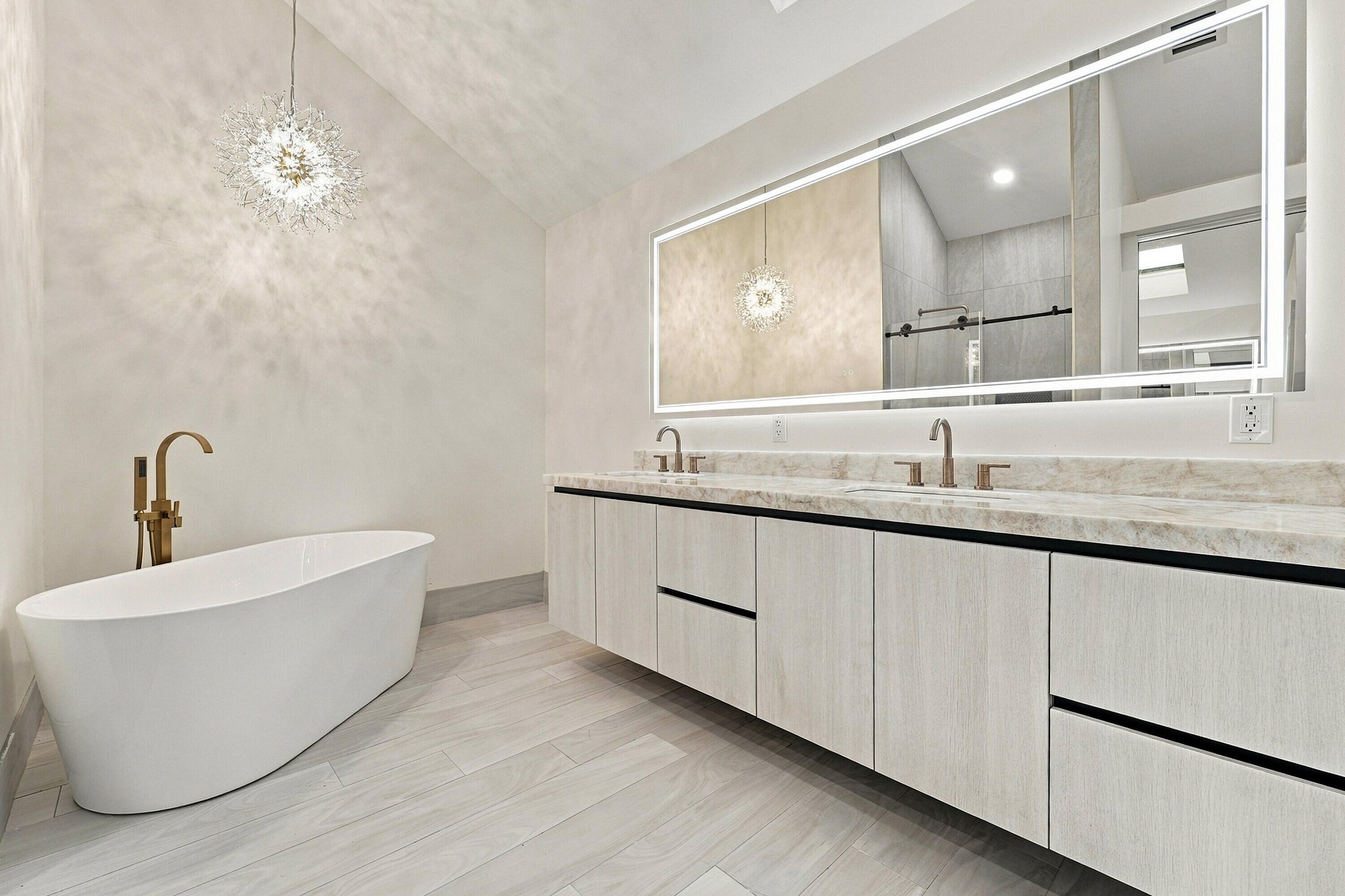 Gorgeous primary bathroom with free standing soaking tub and crystallo quartzite countertops