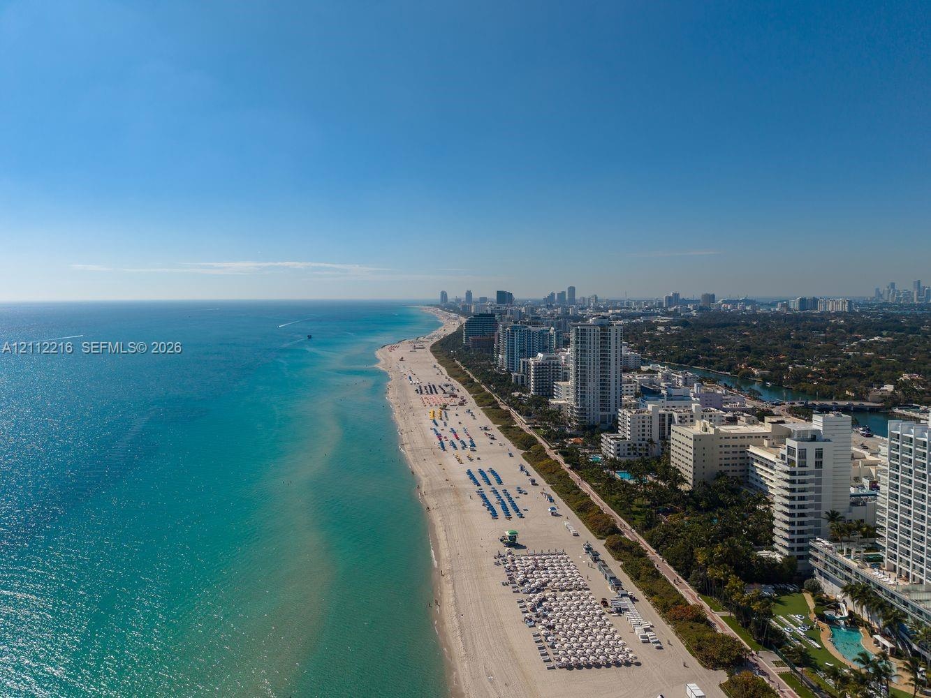 Coastal location featuring direct beach access, expansive shoreline, and proximity to high-rise metropolitan infrastructure