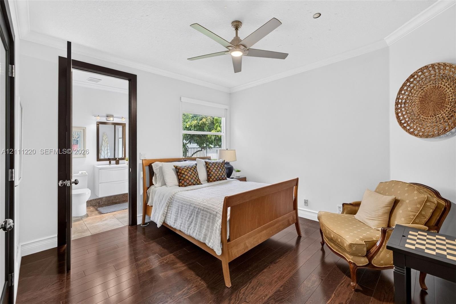Dark wood-finish flooring, recessed lighting, crown molding, and a modern ceiling fan with integrated lighting