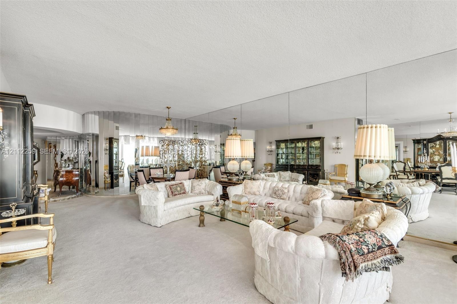 Expansive room featuring floor-to-ceiling wall mirrors and custom curved architectural detailing