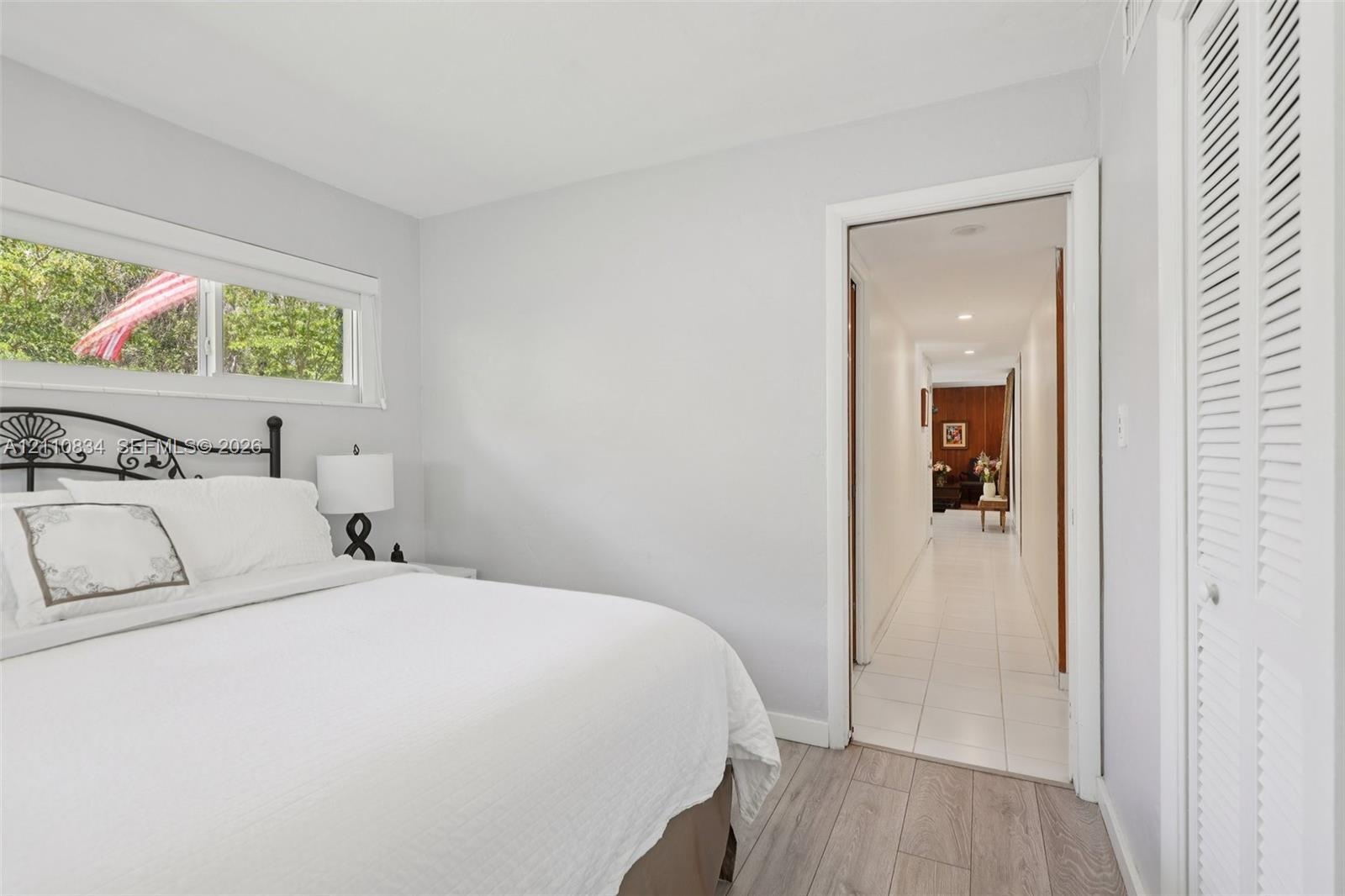 Wood-finish flooring, horizontal sliding window, and louvered closet doors