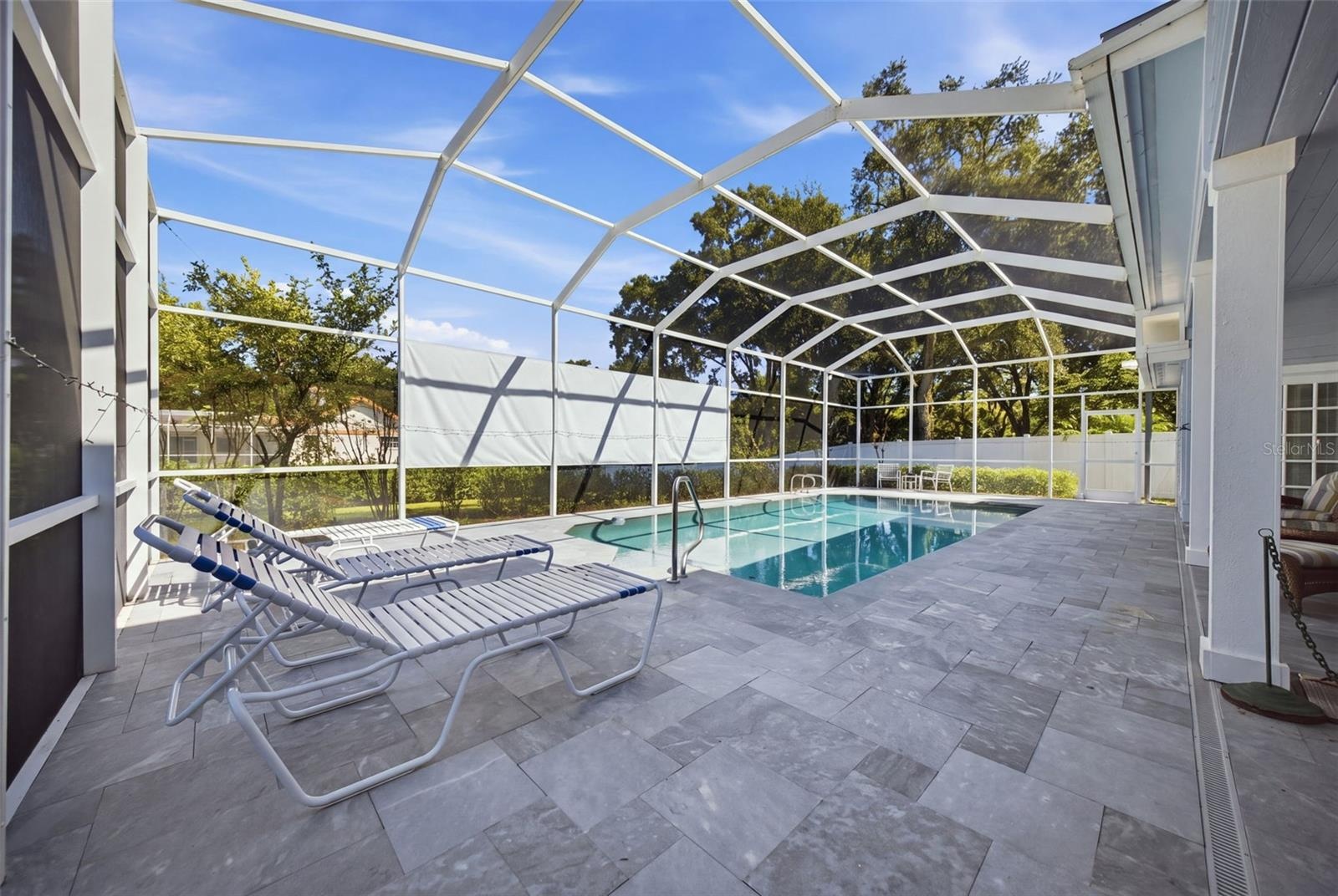 Enclosed Pool and Lanai in blue slate tile.